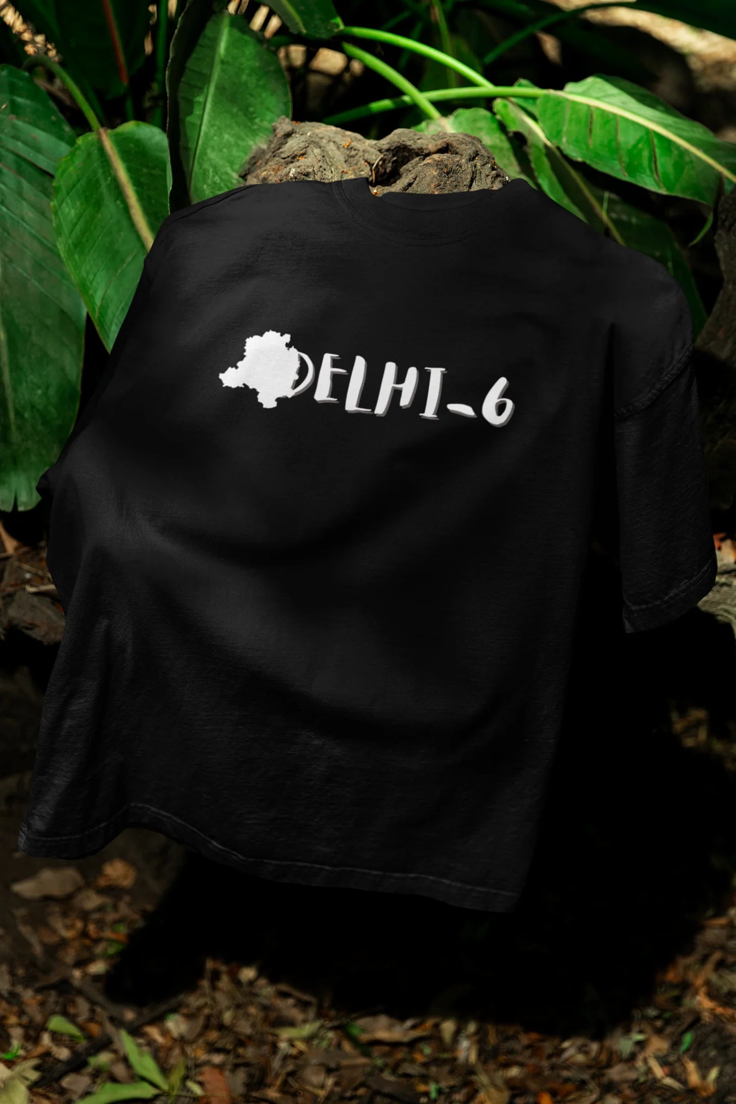 Front view of a black oversized t-shirt featuring a design incorporating the Red Fort and elements representing the city of Delhi, inspired by the Hindi film Delhi 6.