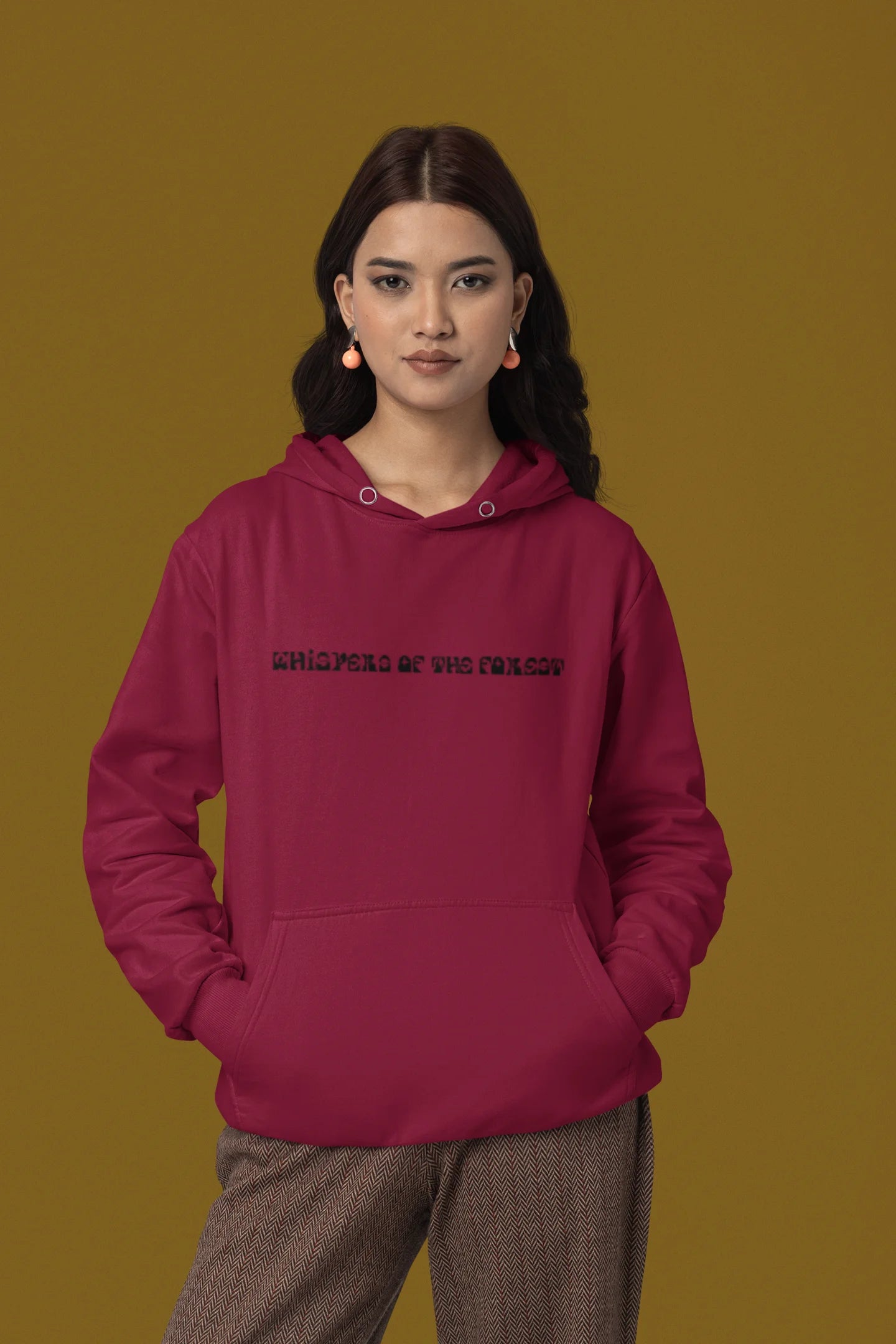 First front view of a female model wearing a maroon hoodie with a design featuring three different types of butterflies, symbolizing the beauty and diversity of nature.