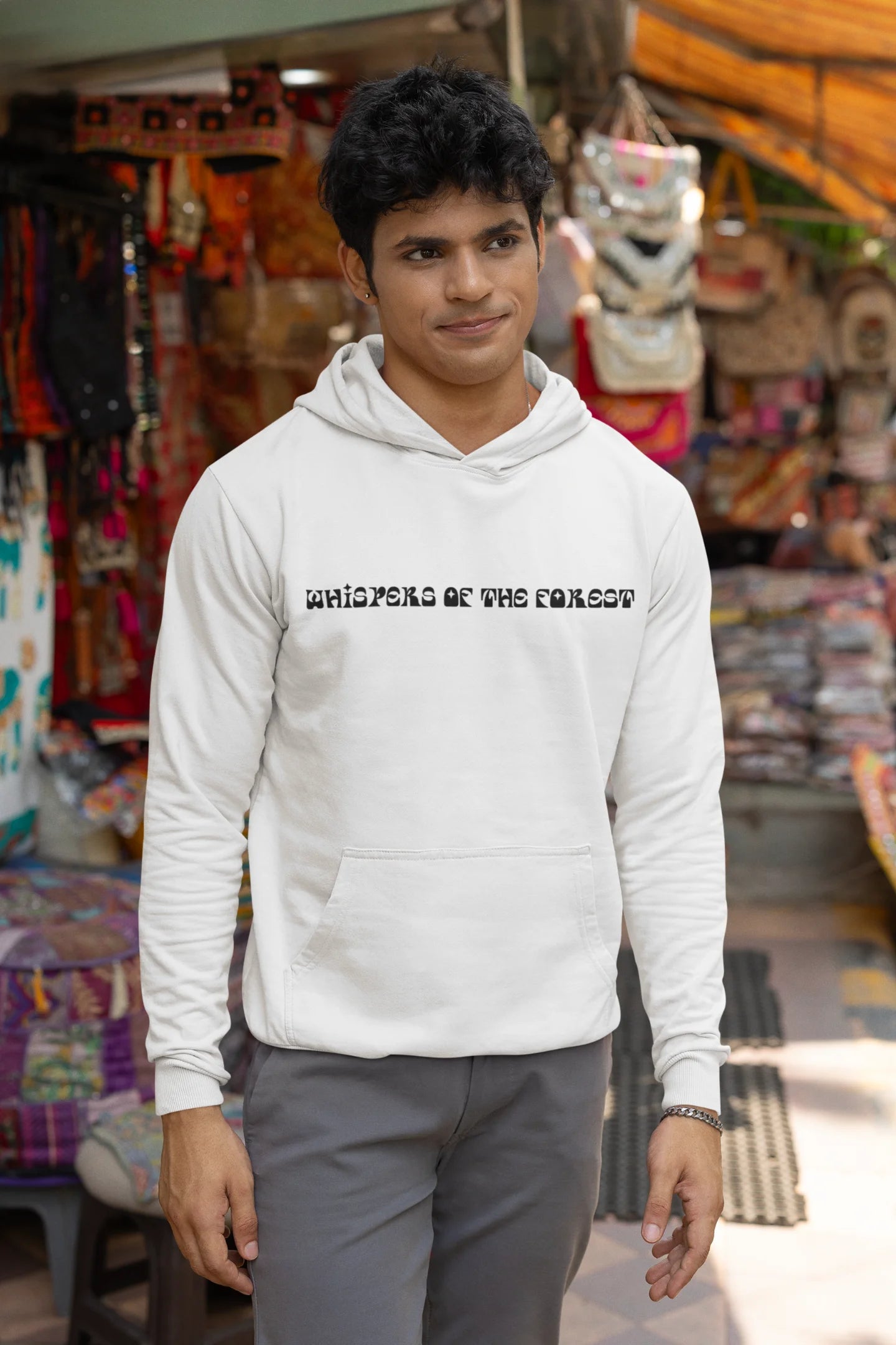 First front view of a male model wearing a white hoodie with a design featuring three different types of butterflies, symbolizing the beauty and diversity of nature.