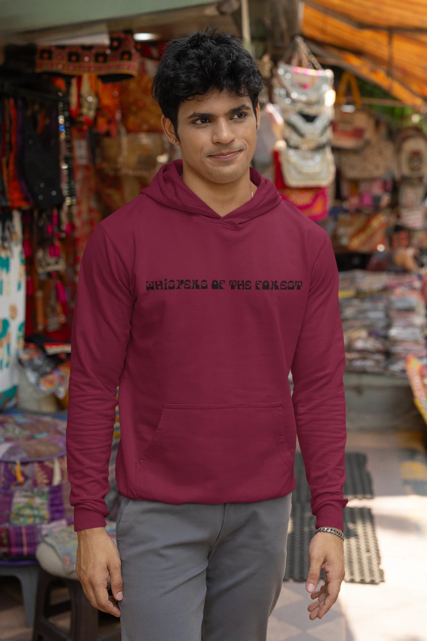First front view of a male model wearing a maroon hoodie with a design featuring three different types of butterflies, symbolizing the beauty and diversity of nature.