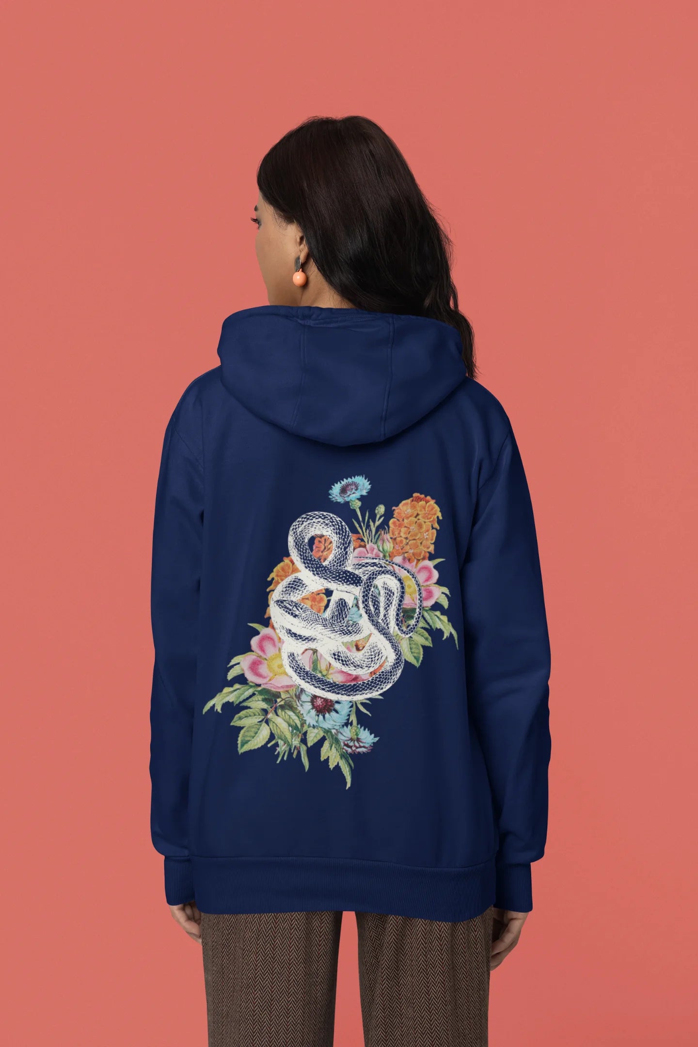 Back view of female model wearing a navy blue hoodie with a snake coiled around flowers, symbolizing the harmony between nature and its creatures.