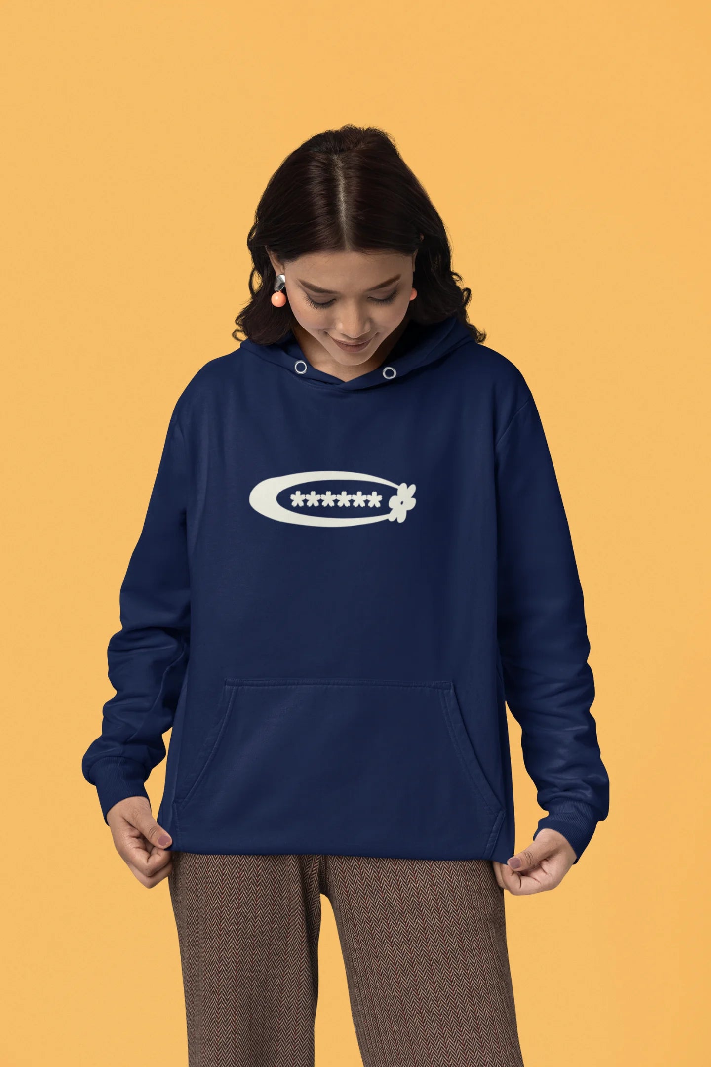 Second front of a female model model wearing a navy hoodie with a design featuring berry bushes overflowing with fruit, symbolizing the abundance and beauty of nature.