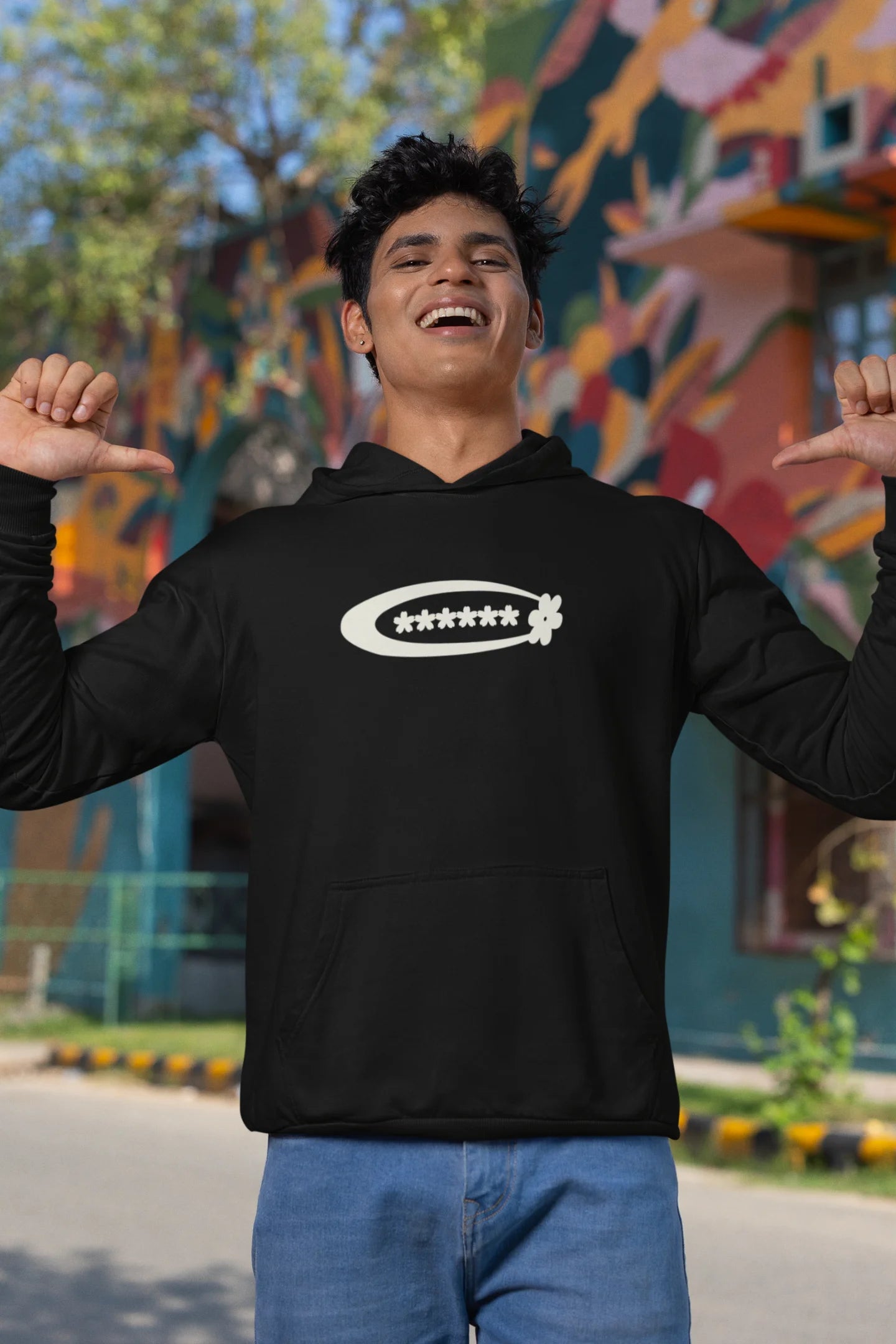 Second front view of a male model model wearing a black hoodie with a design featuring berry bushes overflowing with fruit, symbolizing the abundance and beauty of nature.