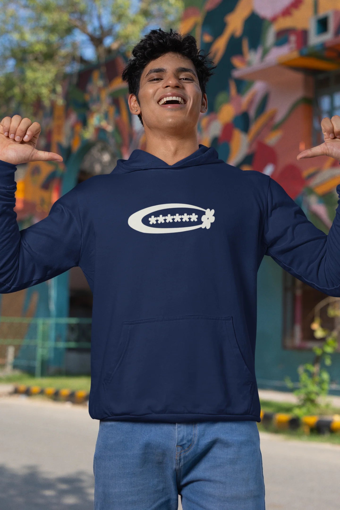 First front of a male model model wearing a navy hoodie with a design featuring berry bushes overflowing with fruit, symbolizing the abundance and beauty of nature.