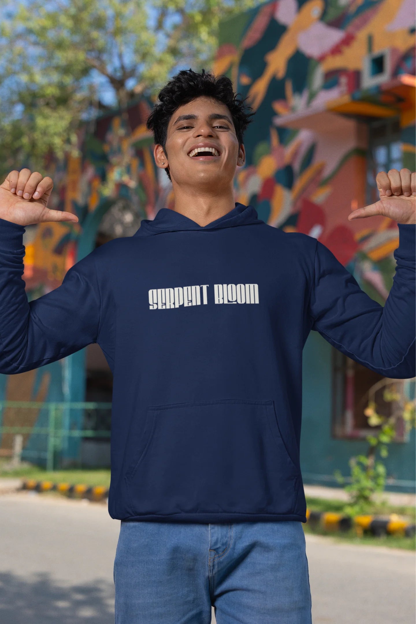 First front view of male model wearing a navy blue hoodie with a snake coiled around flowers, symbolizing the harmony between nature and its creatures.