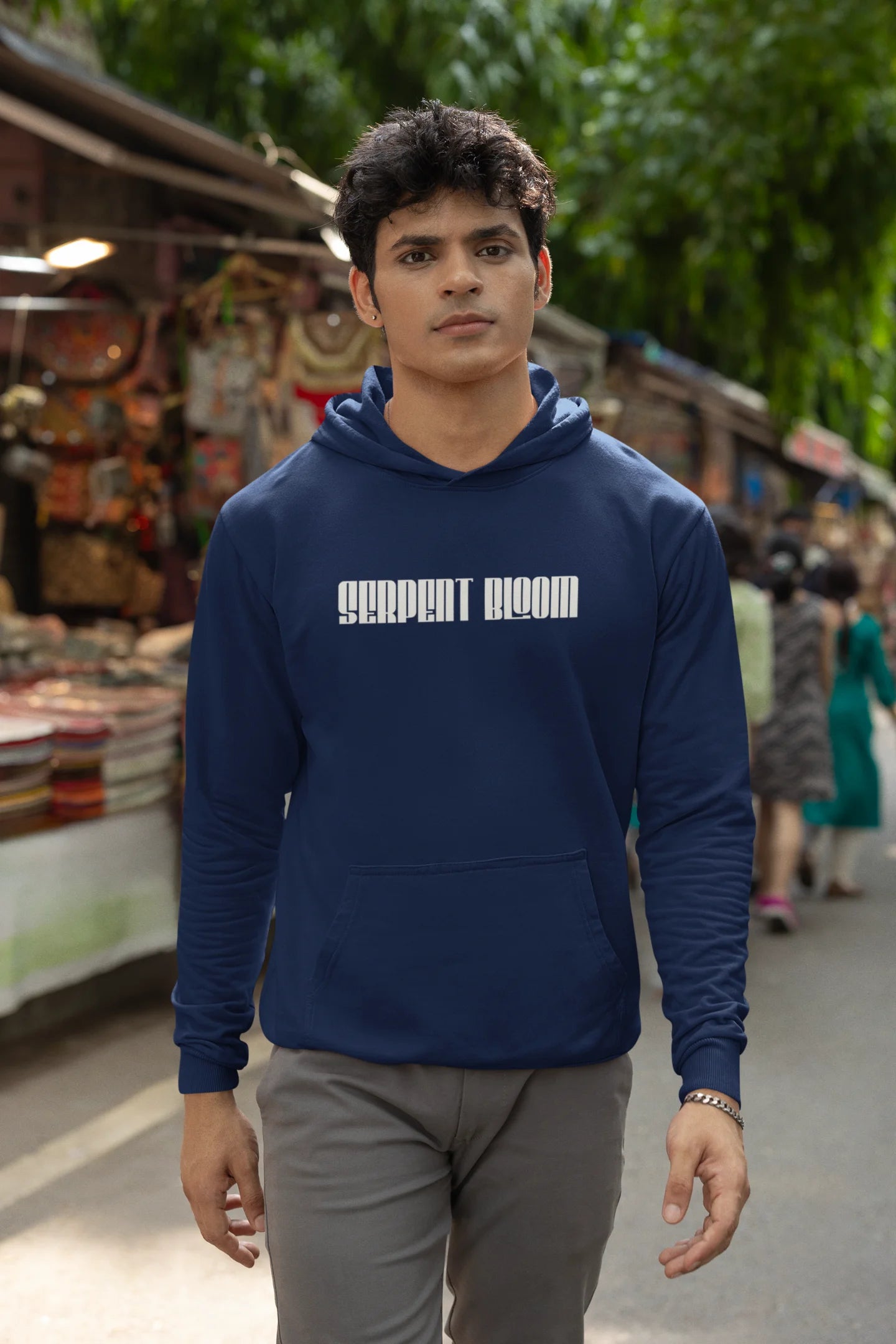 Second front view of male model wearing a navy blue hoodie with a snake coiled around flowers, symbolizing the harmony between nature and its creatures.