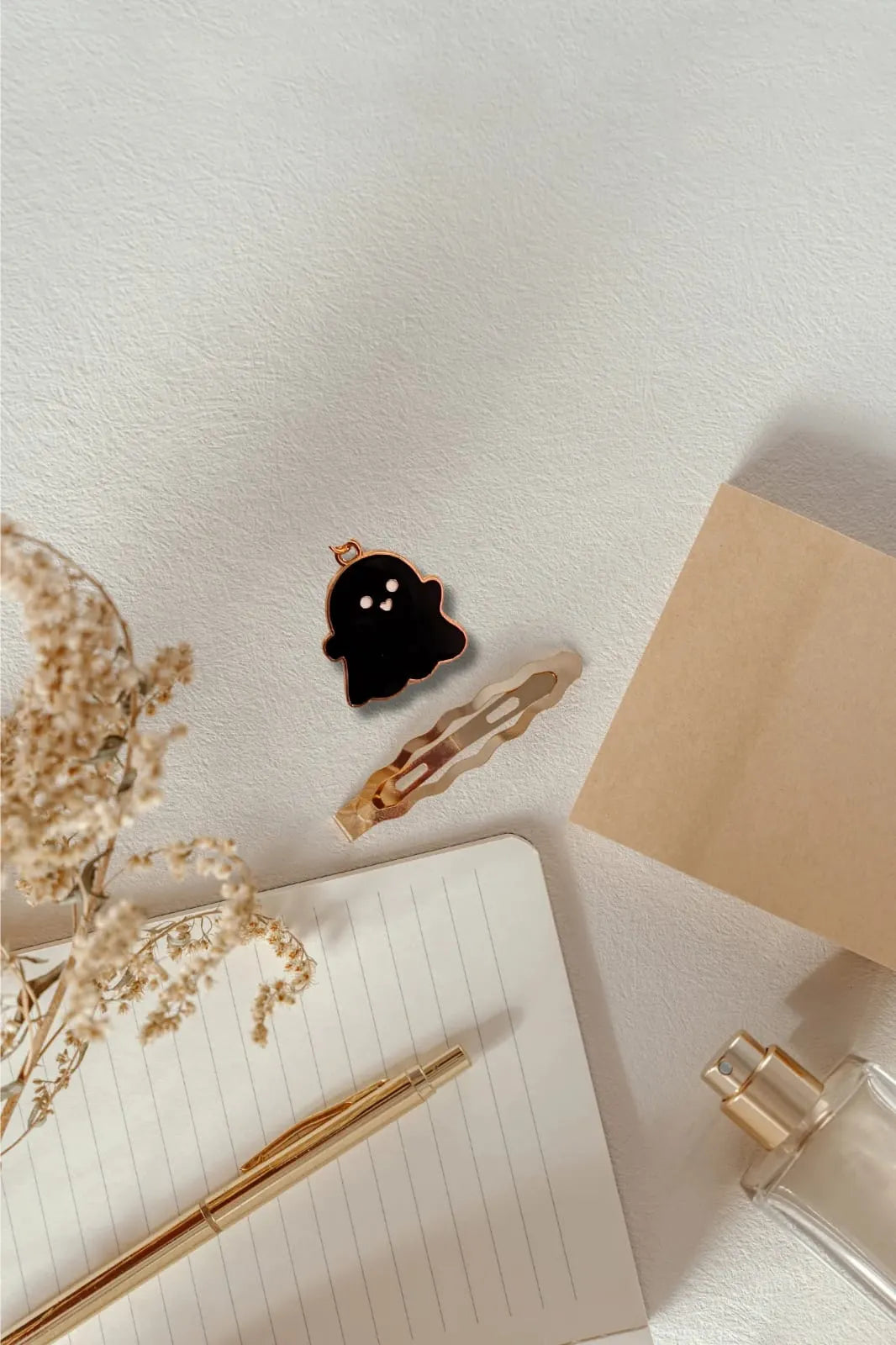 Fifth view of a charm featuring a cute black spooky adorable ghost design.