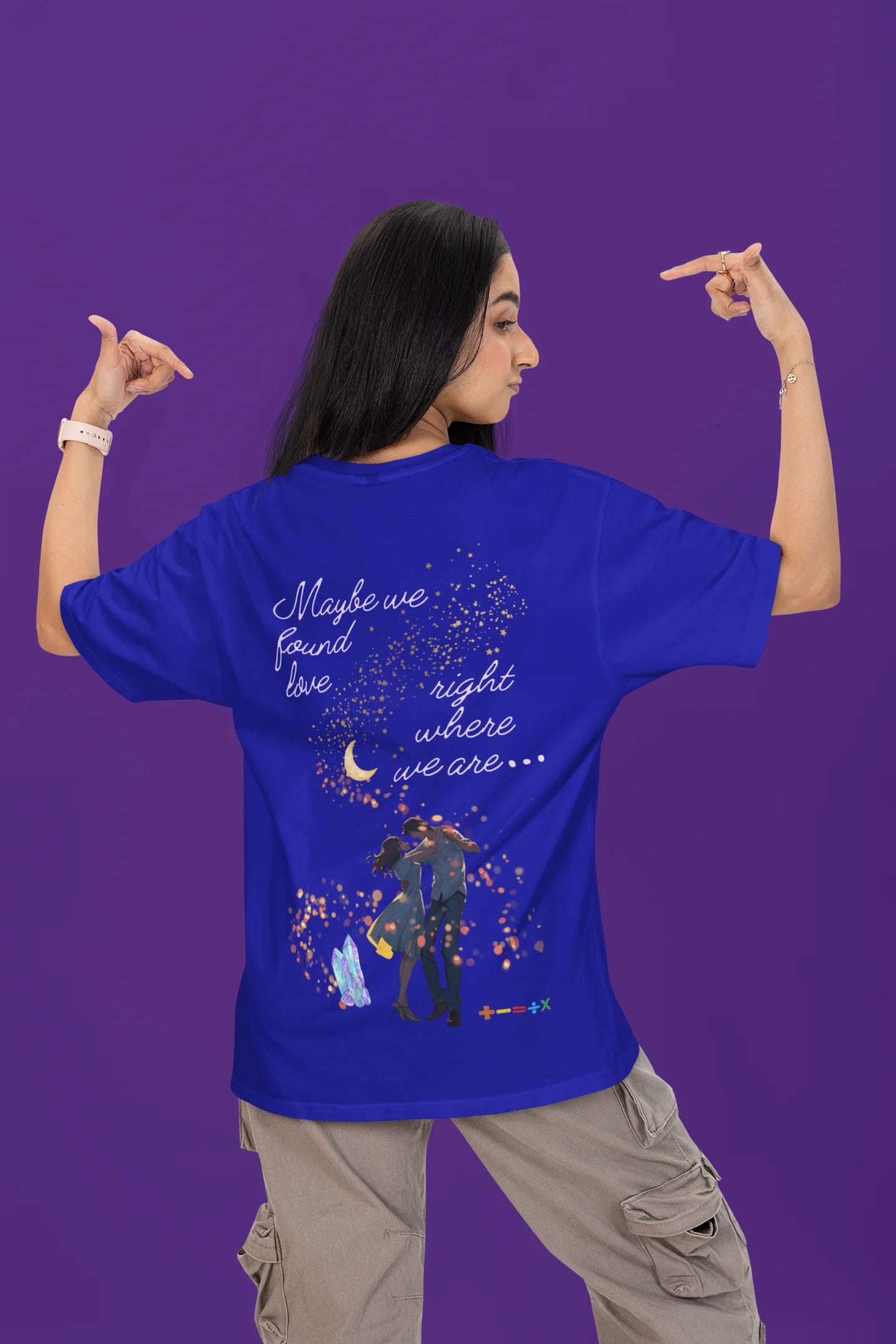 Back view of a female model wearing a royal blue oversized t-shirt featuring a couple dancing in the moonlight, inspired by Ed Sheeran's themes of love.