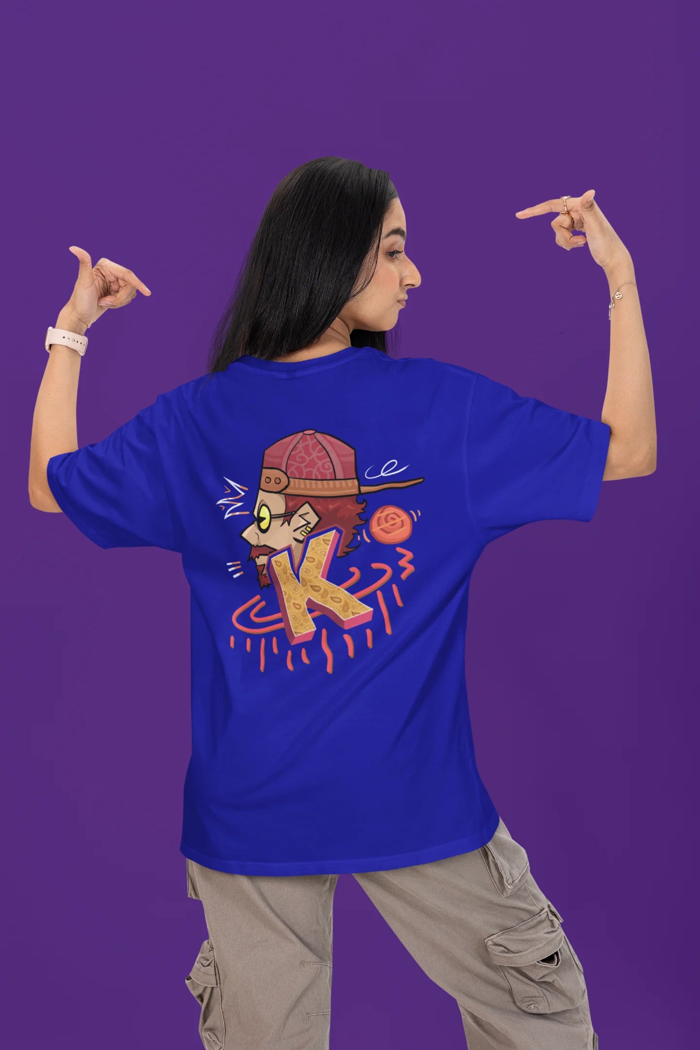 Back view of a female model wearing a royal blue oversized t-shirt featuring the Hindi word for "cool" with a unique, playful design.