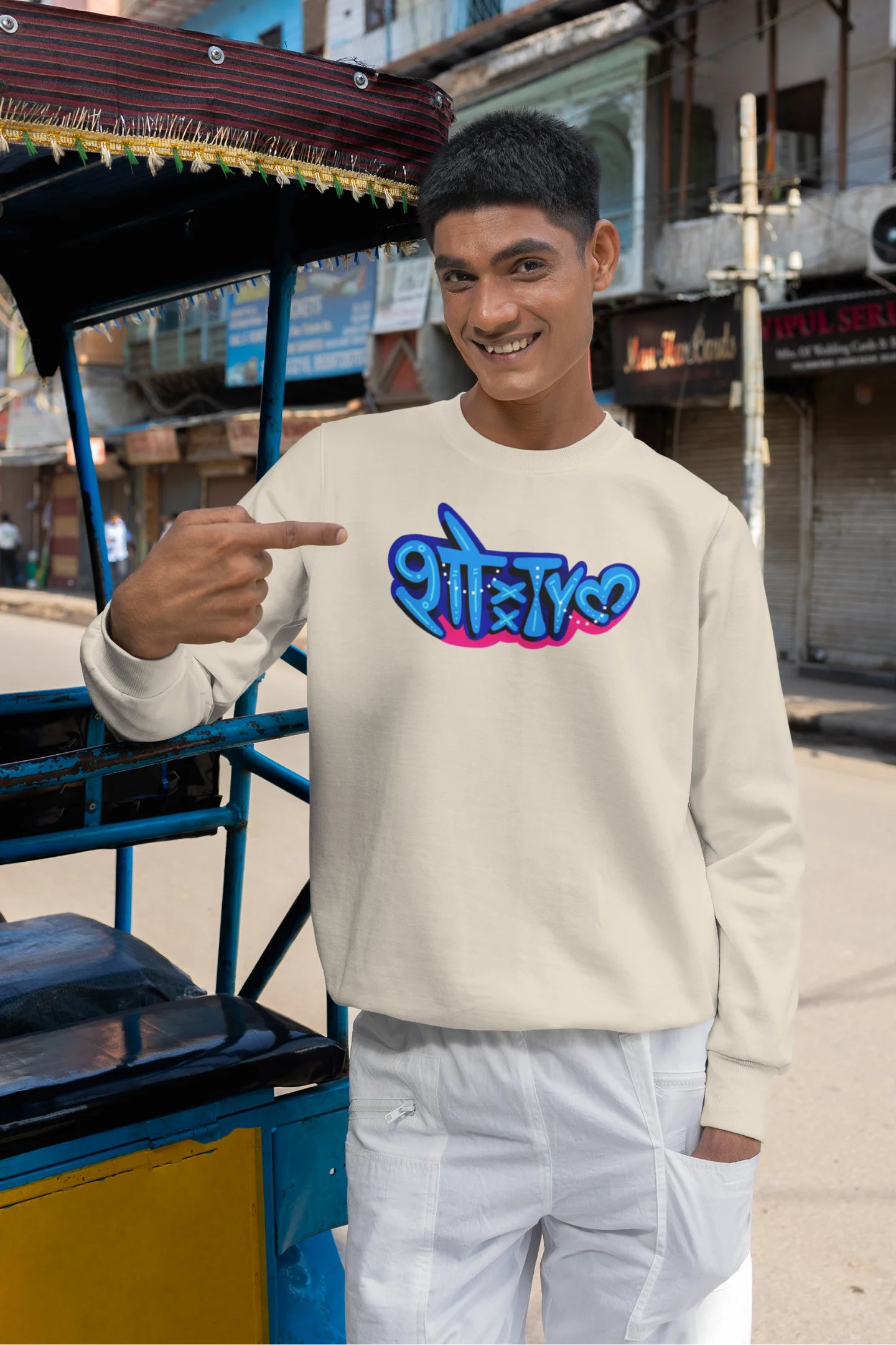 2nd front view of a male model wearing a cream oversized t-shirt featuring "Showtime" in Hindi.