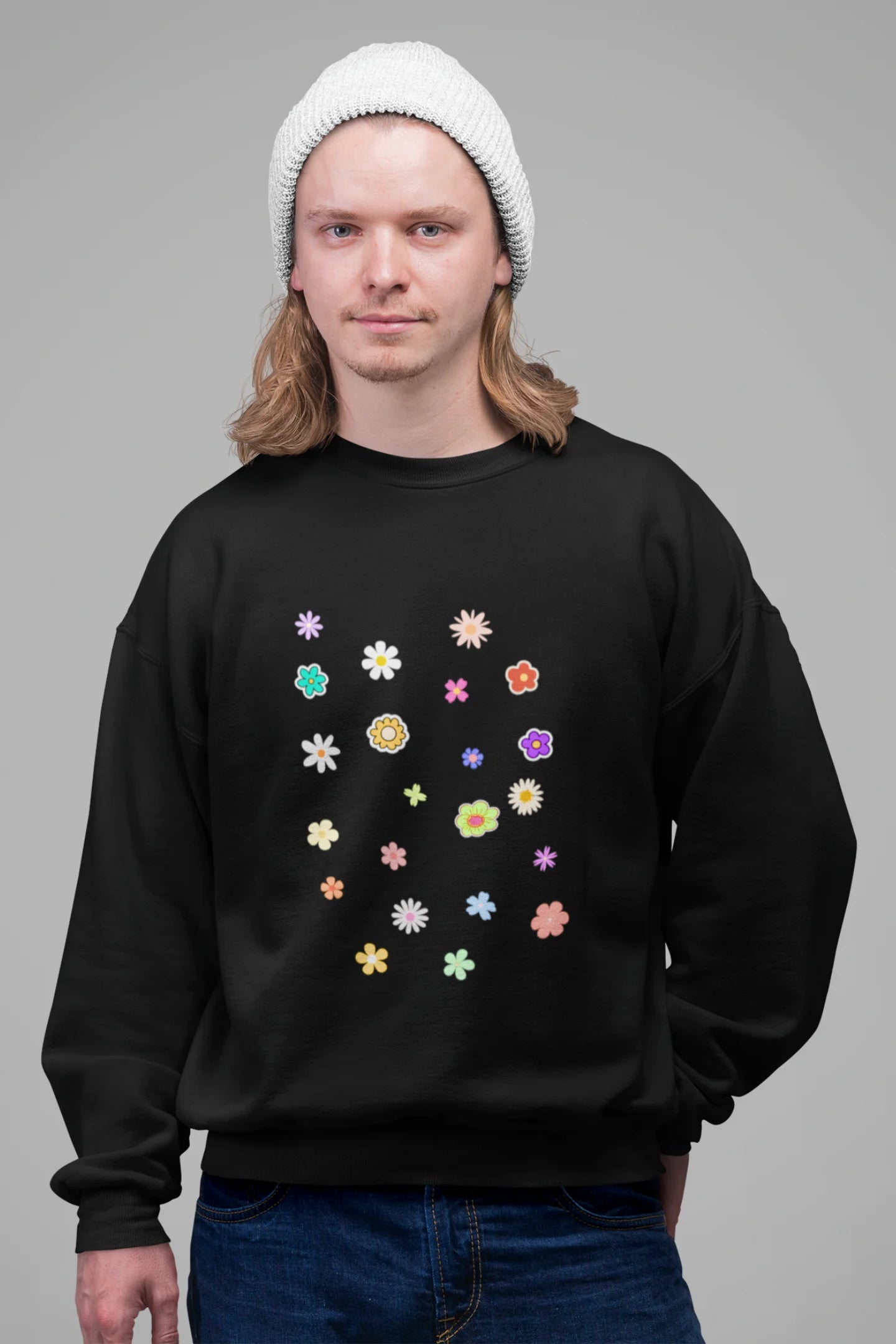 3rd front view of a male model wearing to a black sweatshirt featuring a vibrant floral design with roses, tulips, sunflowers, and orchids. Ideal for those who love floral patterns and spring fashion.