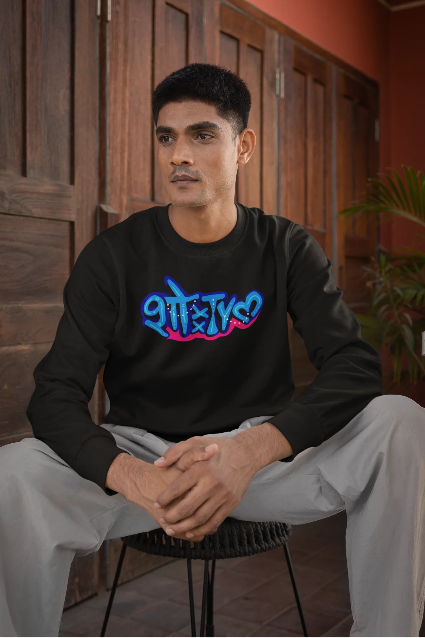 5th front view of a male model wearing a black oversized t-shirt featuring "Showtime" in Hindi.