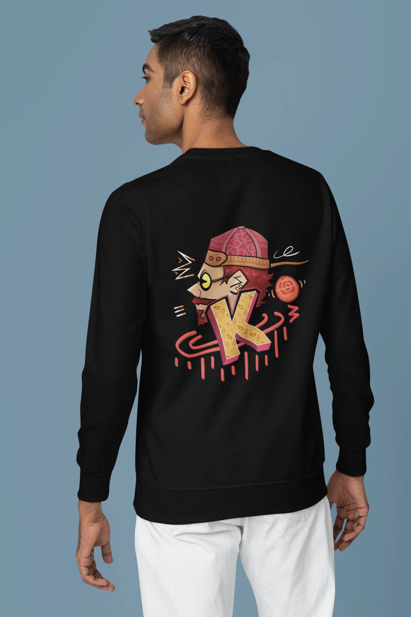 Back view of a male model wearing a black oversized t-shirt featuring the Hindi word for "cool" with a unique, playful design.