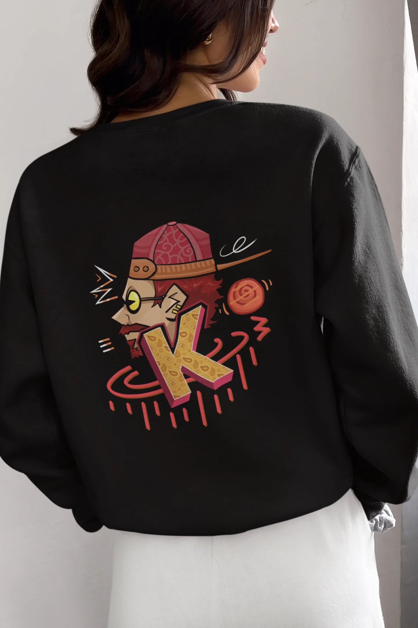 Back view of a female model wearing a black oversized t-shirt featuring the Hindi word for "cool" with a unique, playful design.