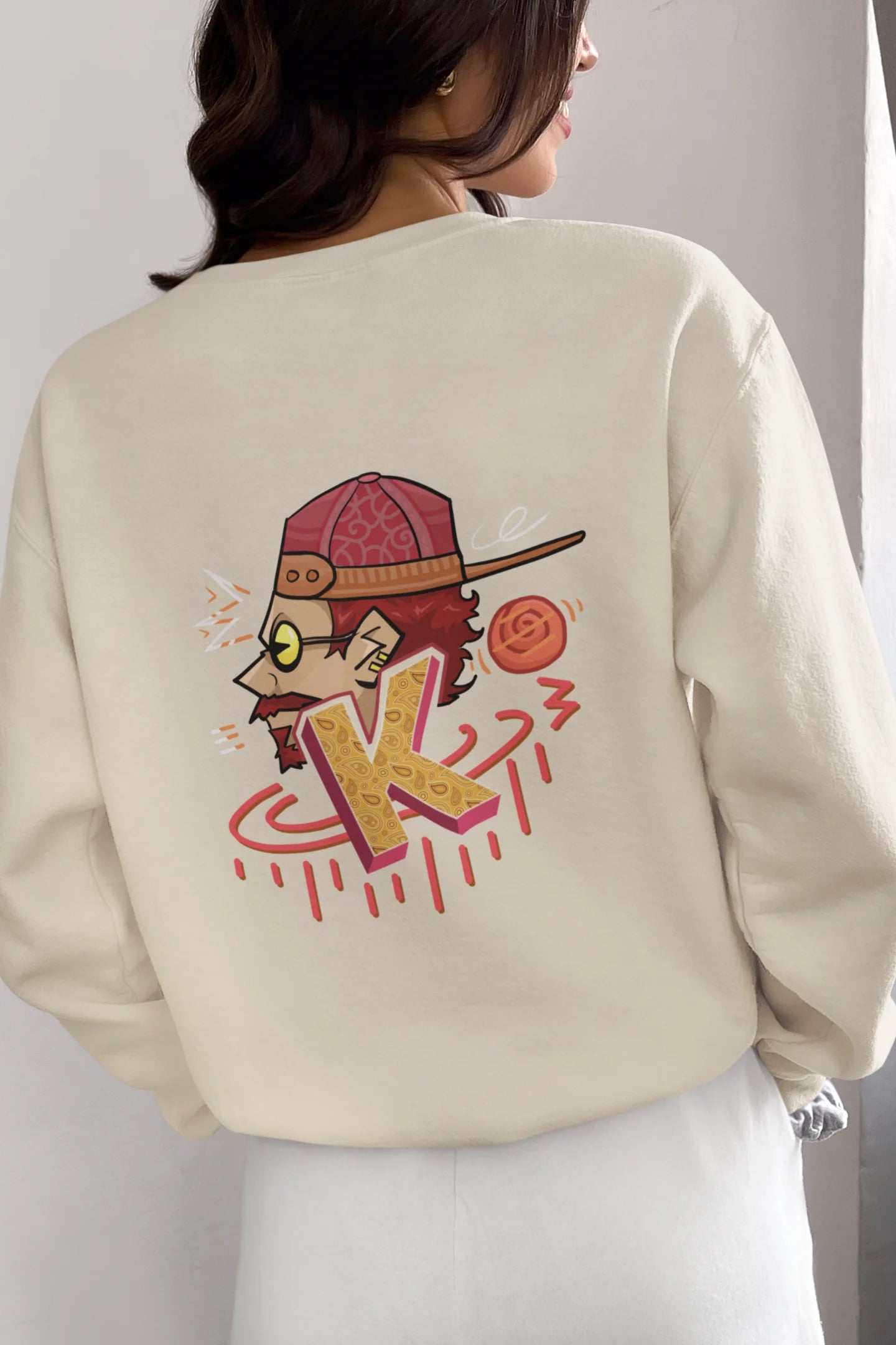 Back view of a female model wearing a cream oversized t-shirt featuring the Hindi word for "cool" with a unique, playful design.
