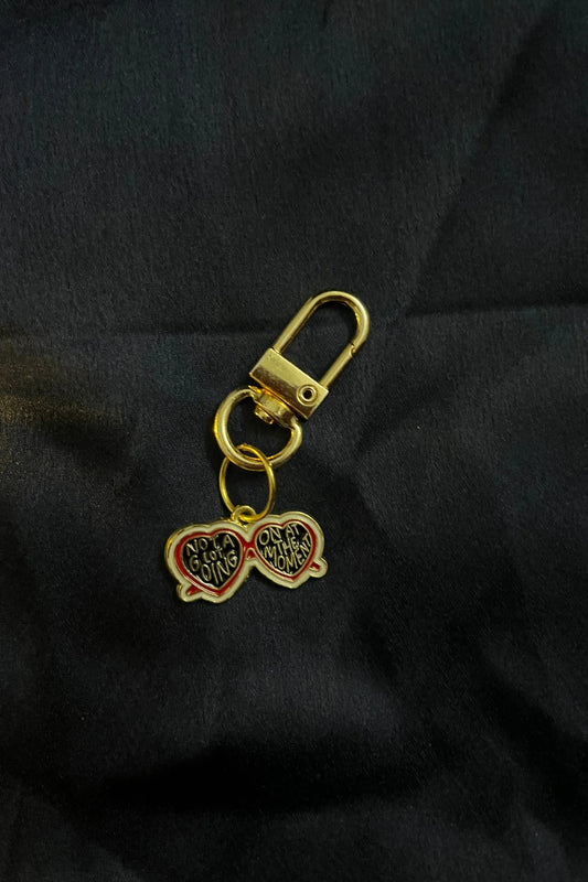 First view of a keychain featuring a design inspired by Taylor Swift's "Evermore" album. Perfect for all swifties.
