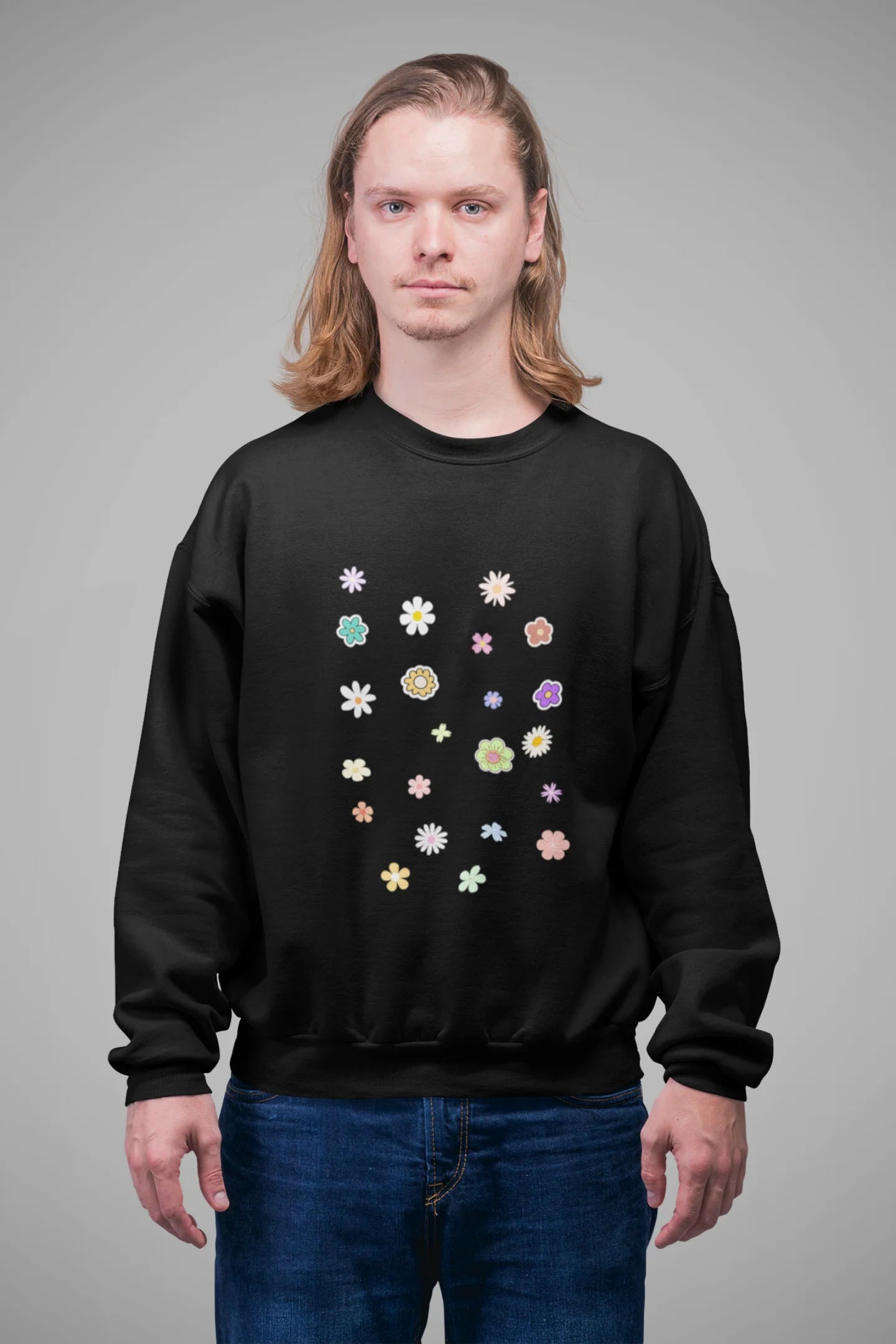 4th front view of a male model wearing to a black sweatshirt featuring a vibrant floral design with roses, tulips, sunflowers, and orchids. Ideal for those who love floral patterns and spring fashion.