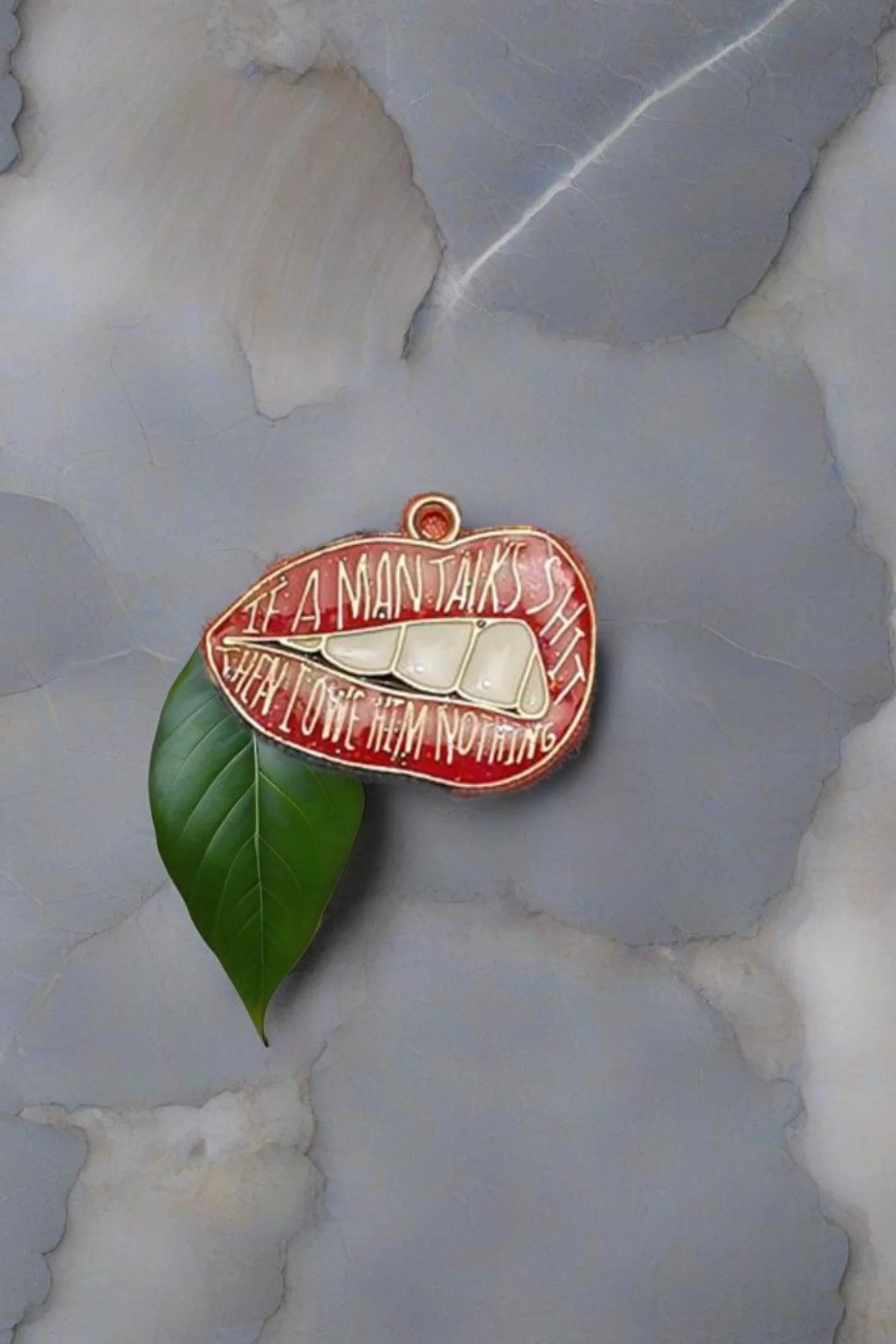 Fifth image of an charm featuring the Taylor Swift phrase "You Owe Him Nothing" on a lip design. Perfect for all Swifties.