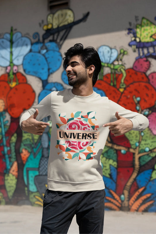First front view of a male model wearing an cream sweatshirt with a cosmic Universe design inspired by Coldplay.