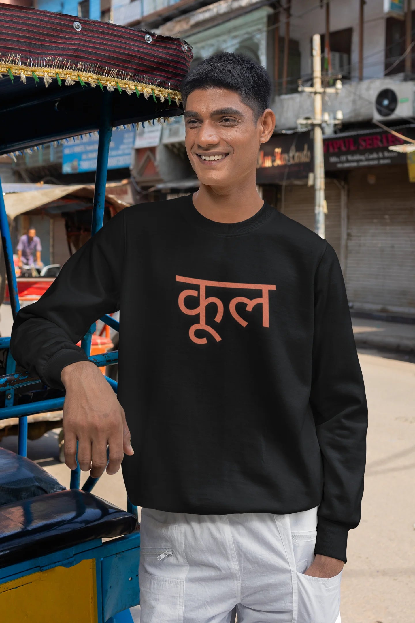 2nd front view of a male model wearing a black oversized t-shirt featuring the Hindi word for "cool" with a unique, playful design.