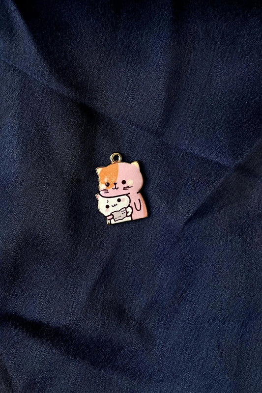 Second view of a charm featuring a design of a mother cat and her kitten.