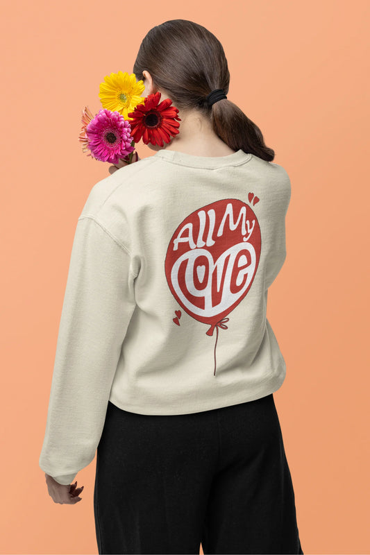 Back view of a female model wearing a cream sweatshirt with a heart design and the text "All My Love".