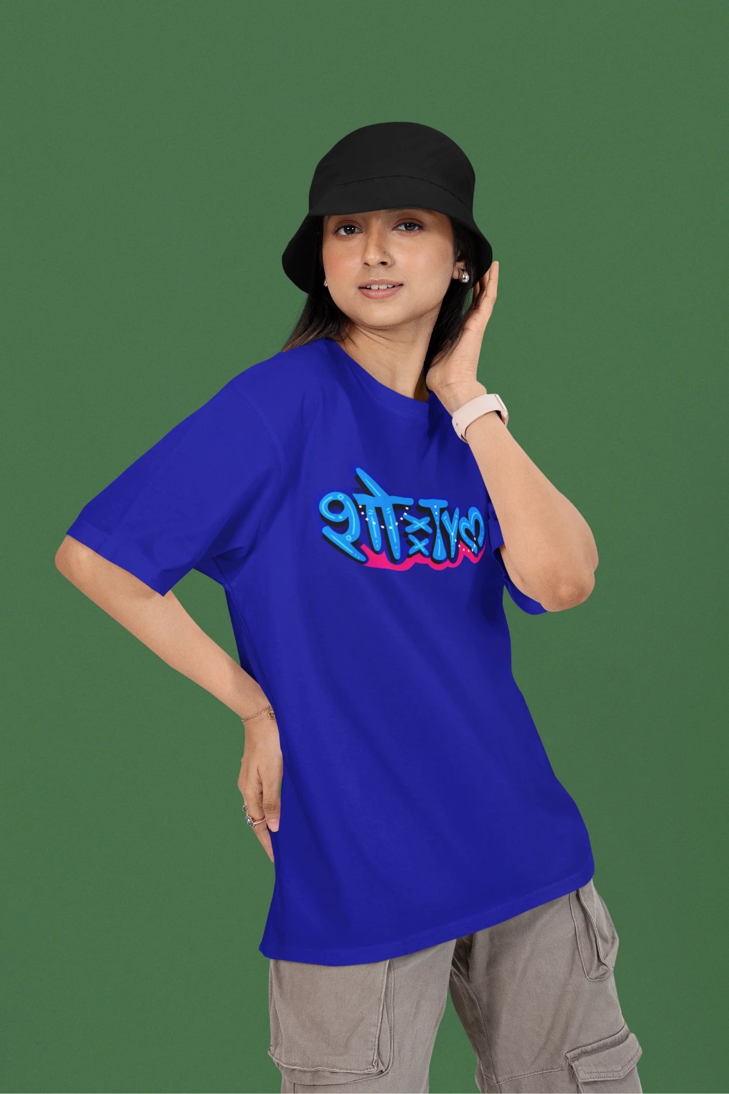 3rd front view of a female model wearing a royal blue oversized t-shirt featuring "Showtime" in Hindi.