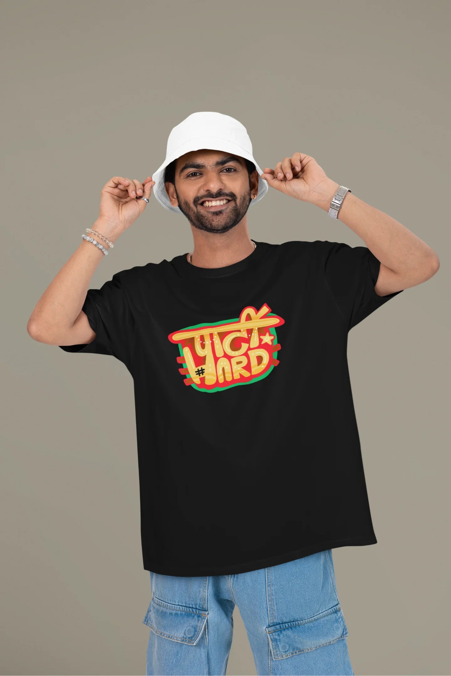 3rd front view of a male model wearing a black oversized t-shirt with the phrase "Party Hard" in an energetic Hindi.