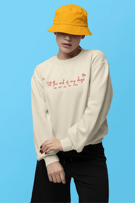 First front view of a female model wearing a cream sweatshirt with a heart design and the text "All My Love".