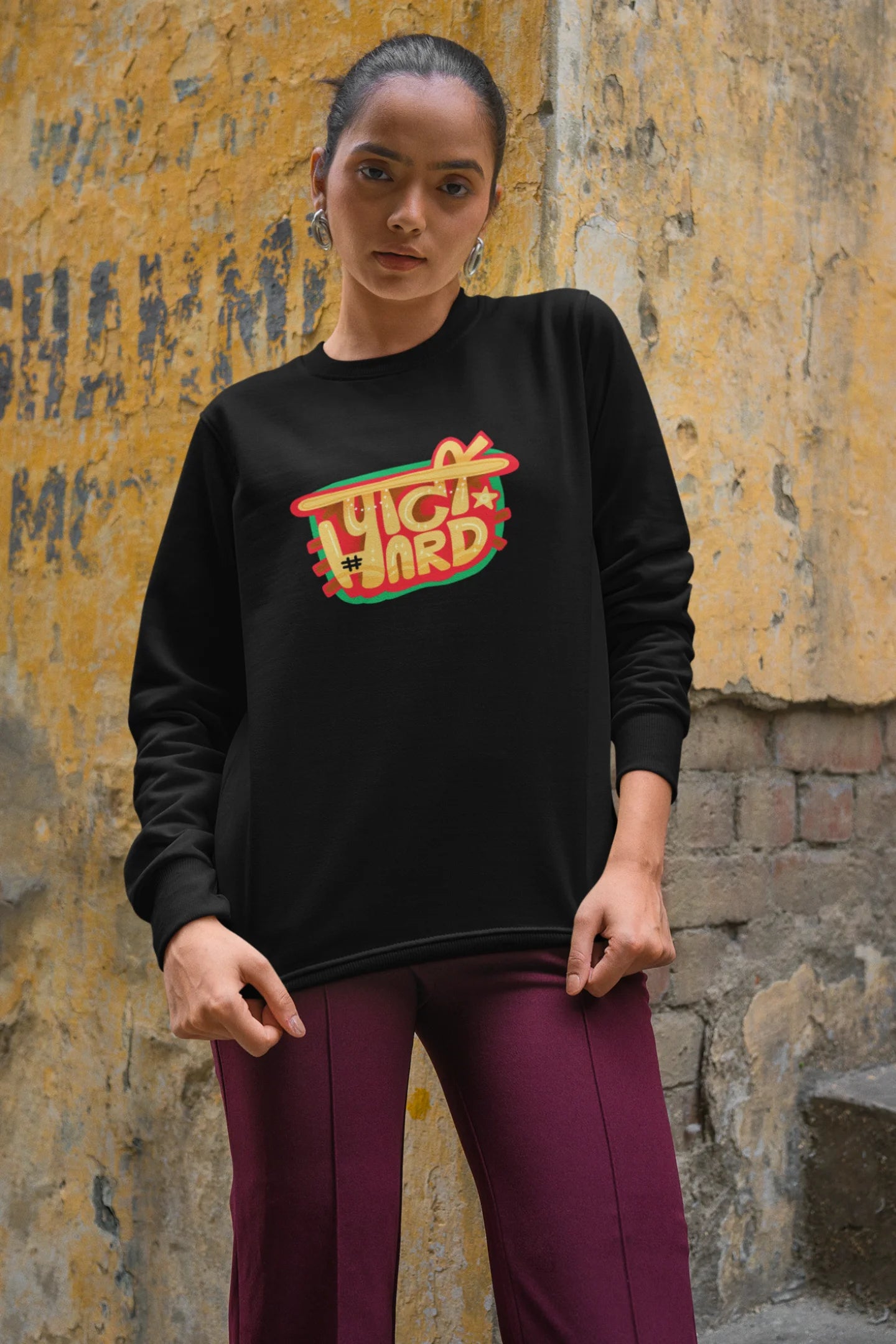2nd front view of a female model wearing a black oversized t-shirt with the phrase "Party Hard" in an energetic Hindi.