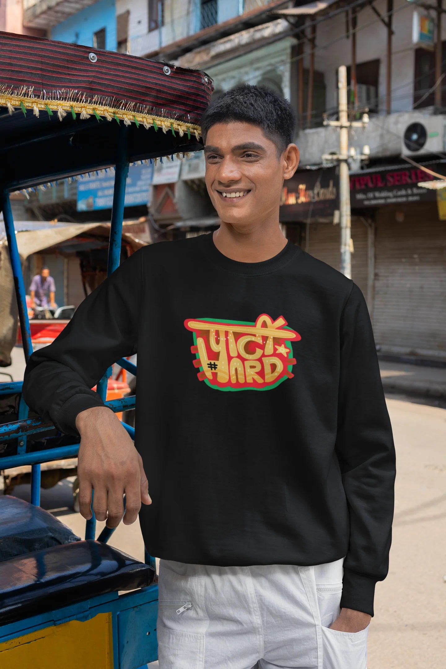 3rd front view of a male model wearing a black oversized t-shirt with the phrase "Party Hard" in an energetic Hindi.