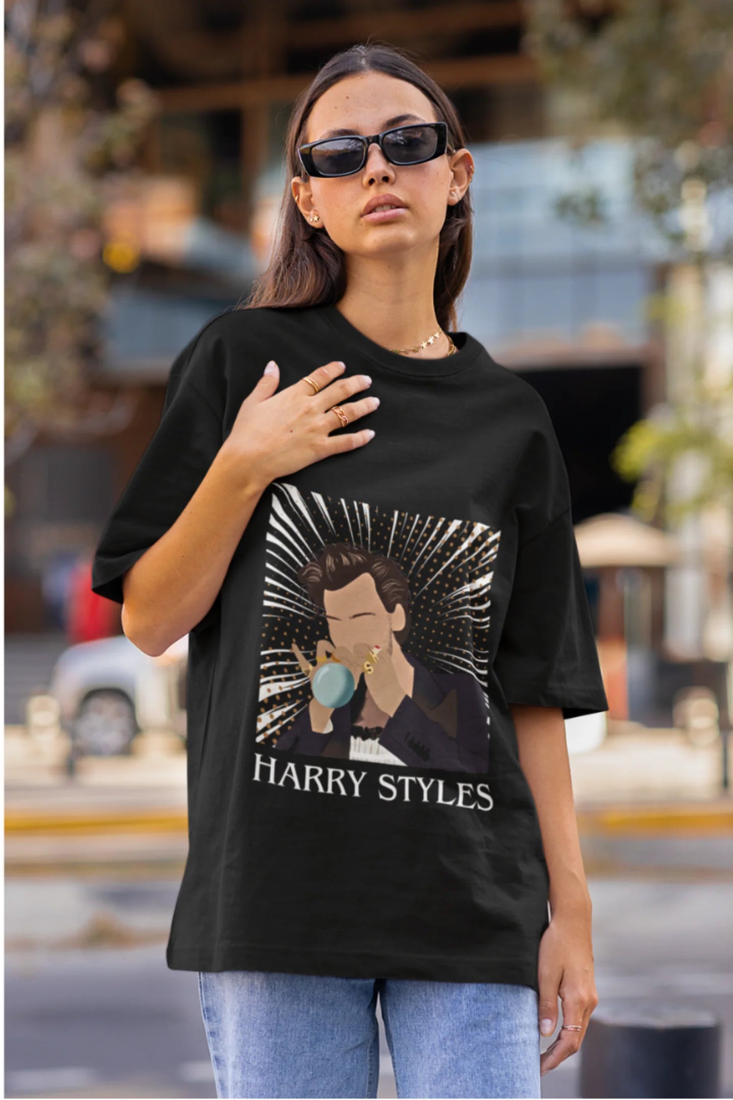 First image of woman wearing One Direction-inspired black oversized t-shirt with Harry Styles design - ideal Harry Styles merch for fans of 1D and Harry Styles