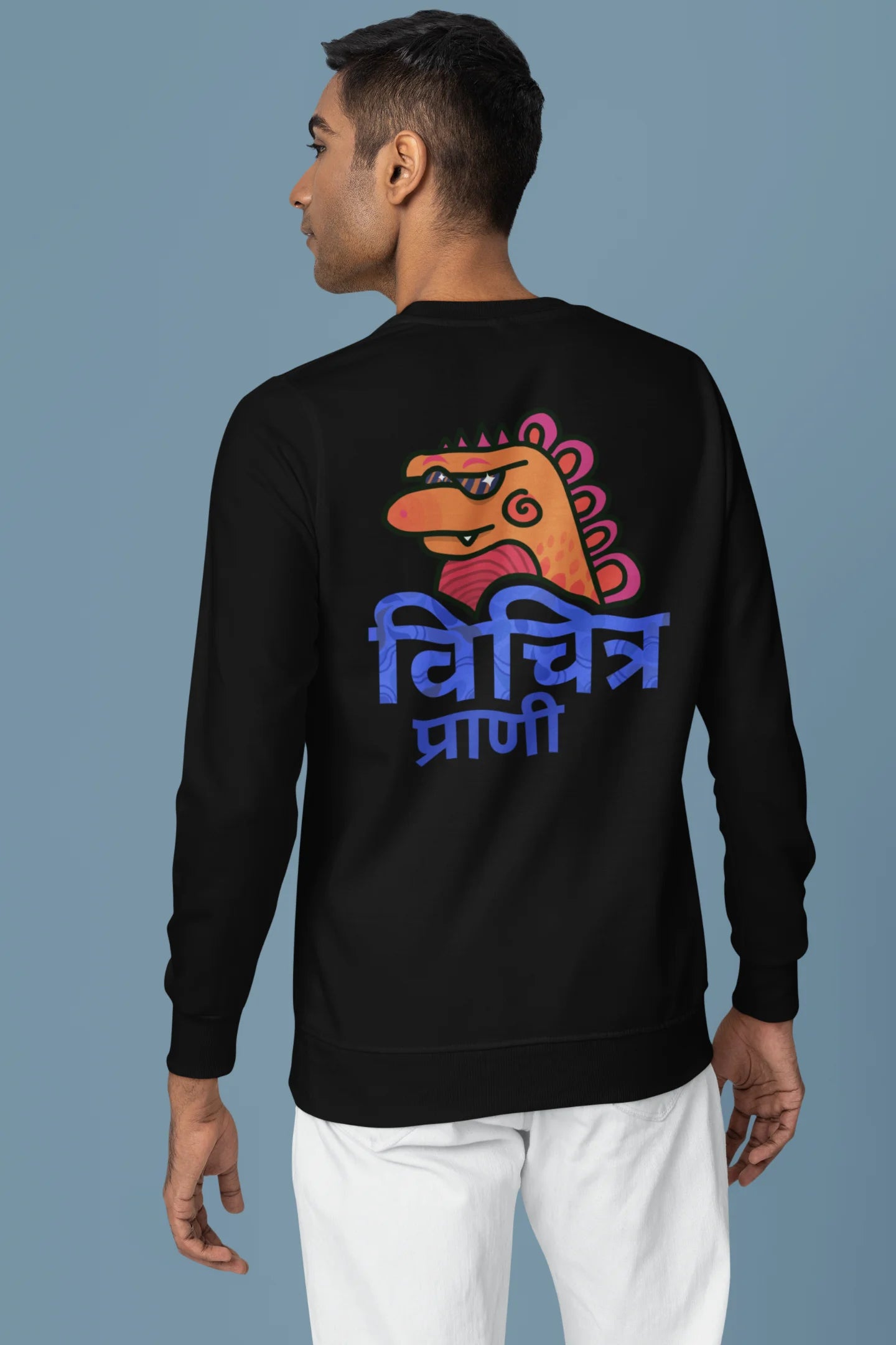 Back view of a male model wearing a black sweatshirt with the phrase "Vichitra Pranee" (meaning "Strange being" or "alien") in a stylish Hindi font.