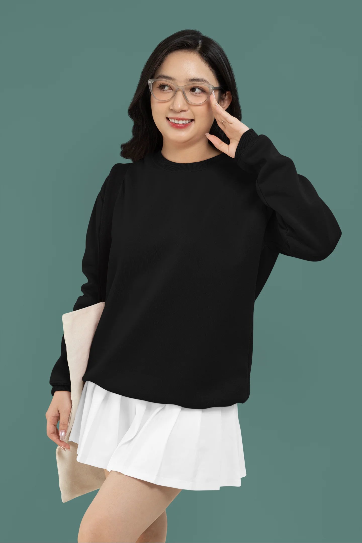 First front view of a female model wearing a black sweatshirt featuring a stunning design of corals and shells, evoking a serene underwater atmosphere.