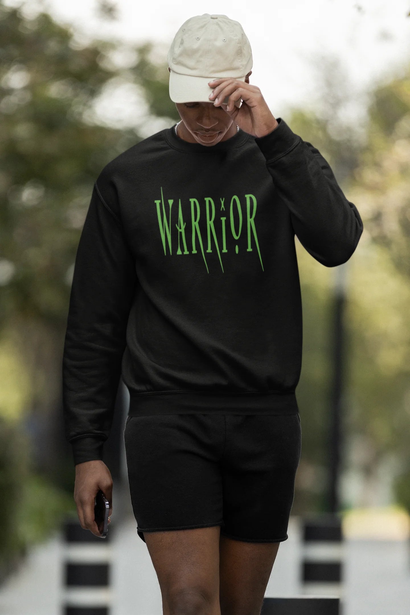 Third front view of a male model wearing a black sweatshirt with a brutalist warrior and horseback battle design.