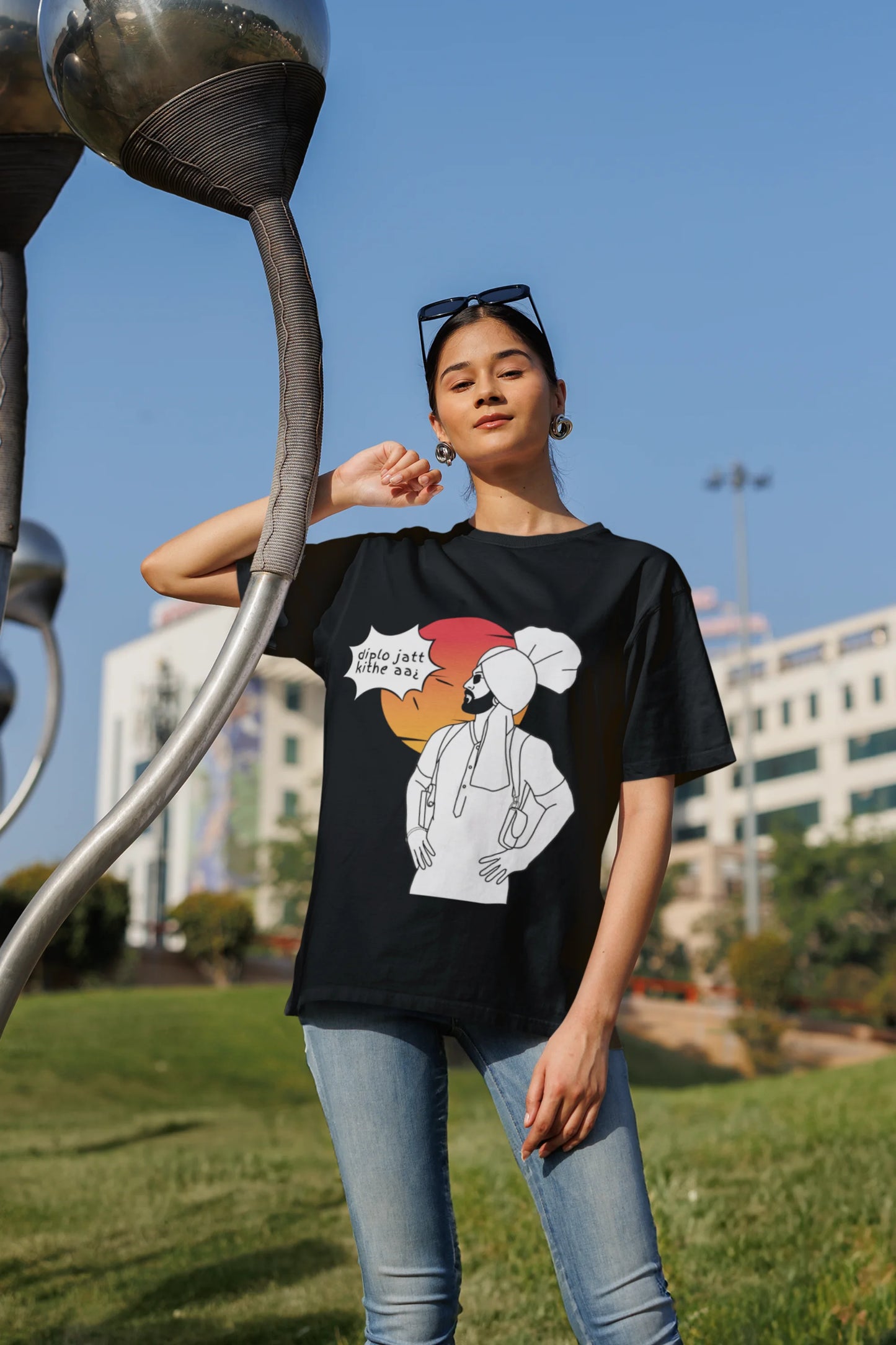 First image of a female model wearing a black oversized tshirt with a A portrait of Diljit Dosanjh wearing a stylish outfit, with the text "Diplo Jatt Kithe Aai" prominently displayed in the background. The design captures the artist's charisma and the energy of the hit song, making it a must-have for fans of Diljit Dosanjh and Diplo alike.