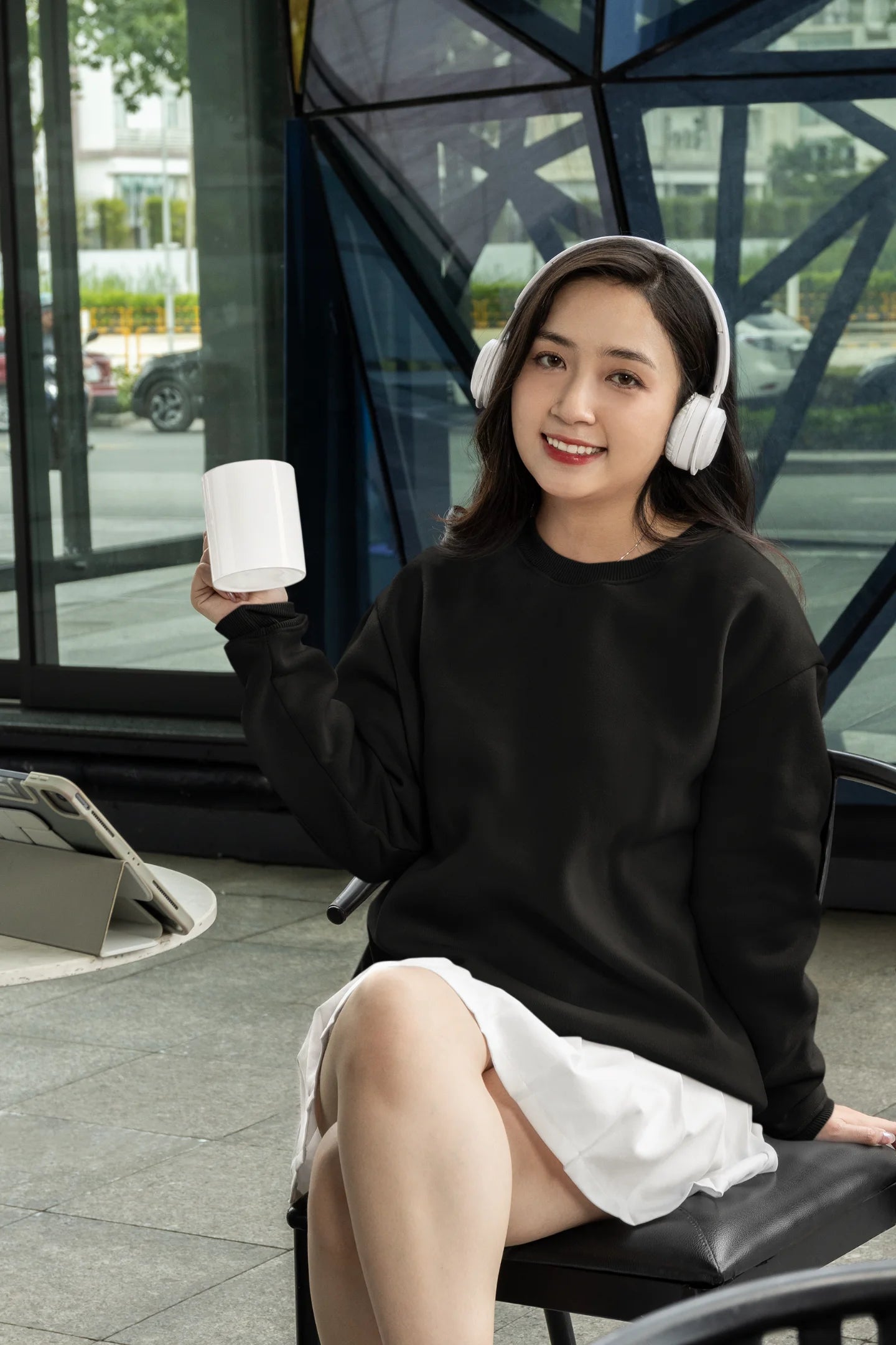 3rd front view of a female model wearing a black sweatshirt featuring a stunning design of corals and shells, evoking a serene underwater atmosphere.