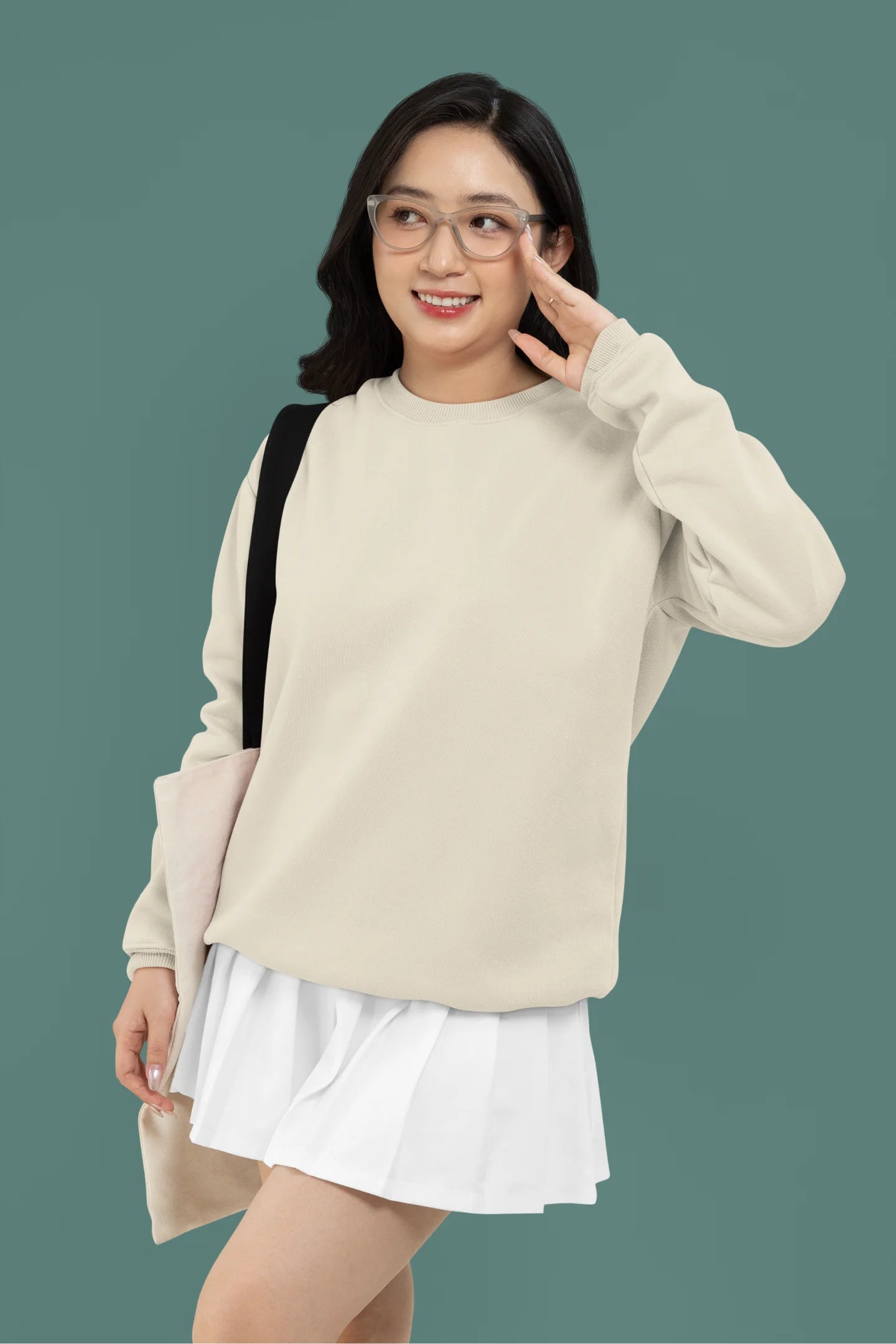 First front view of female model wearing an cream sweatshirt featuring a thought-provoking design of a golden lock shaped like an insect. Ideal for those who love symbolic clothing and unique conversation starters.