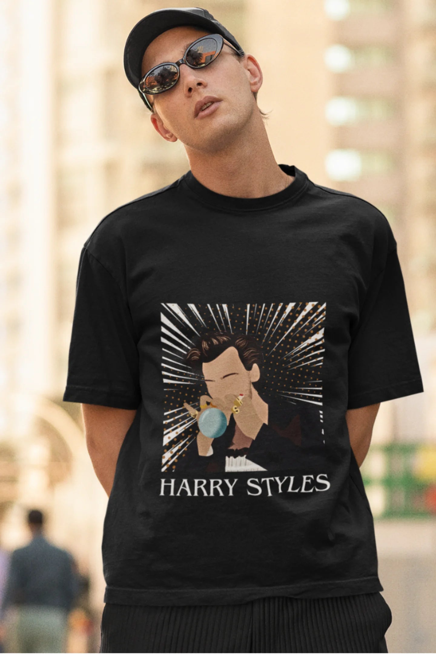 Second image of man wearing One Direction-inspired black oversized t-shirt with Harry Styles design - ideal Harry Styles merch for fans of 1D and Harry Styles