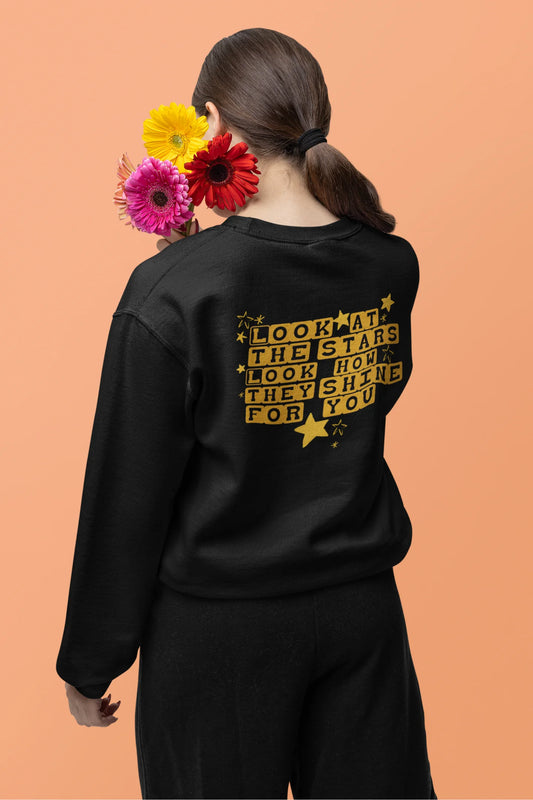 Back view of a female model wearing a black sweatshirt with the "Yellow" album artwork by Coldplay.