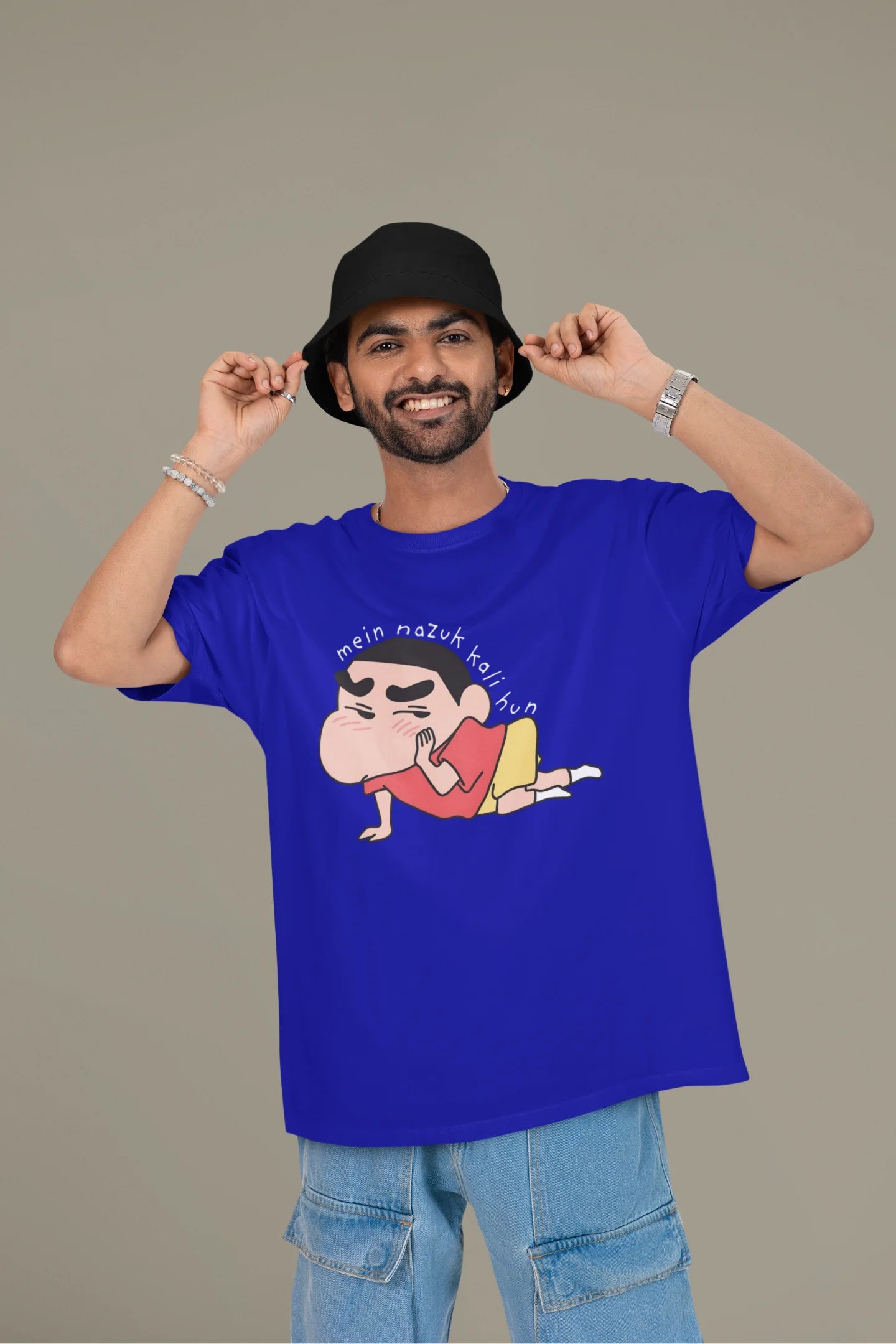 First front view of a male model wearing a royal blue oversized t-shirt featuring Shinchan saying "Mein Nazuk Kali Hun."