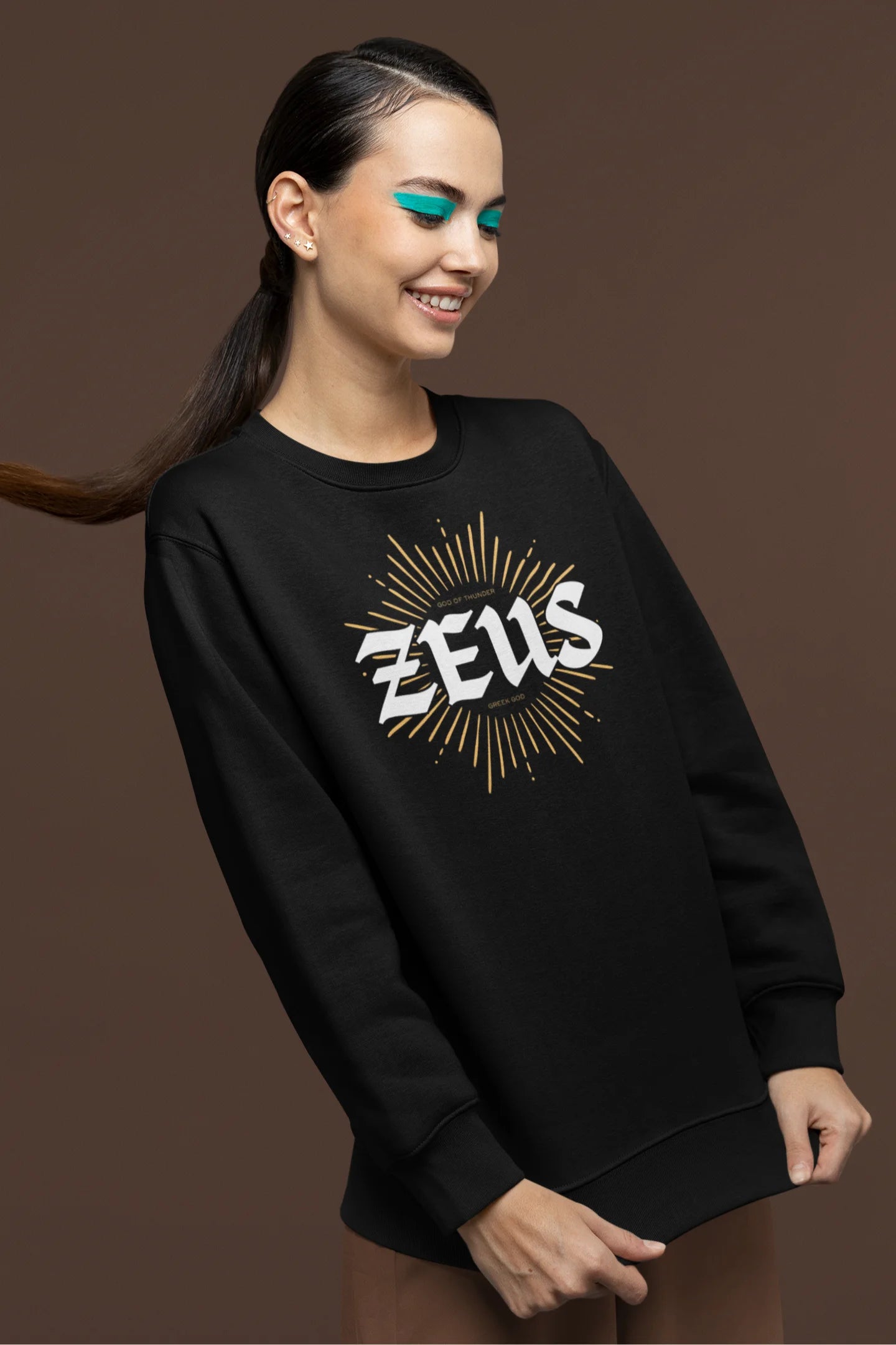 Second front view of a female model wearing a brutalist-inspired black sweatshirt with a stylized image of Zeus, king of the gods, in a concrete-like design.