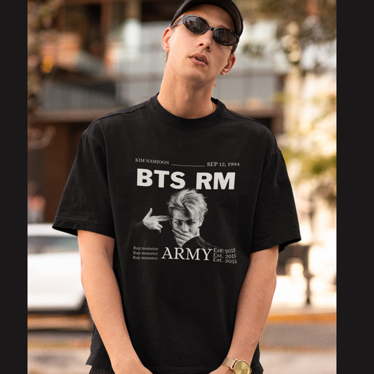 Front view of male model wearing a black oversized t-shirt featuring a design representing all seven members of BTS. Ideal for BTS fans (ARMY) who want to show their love for the entire group.