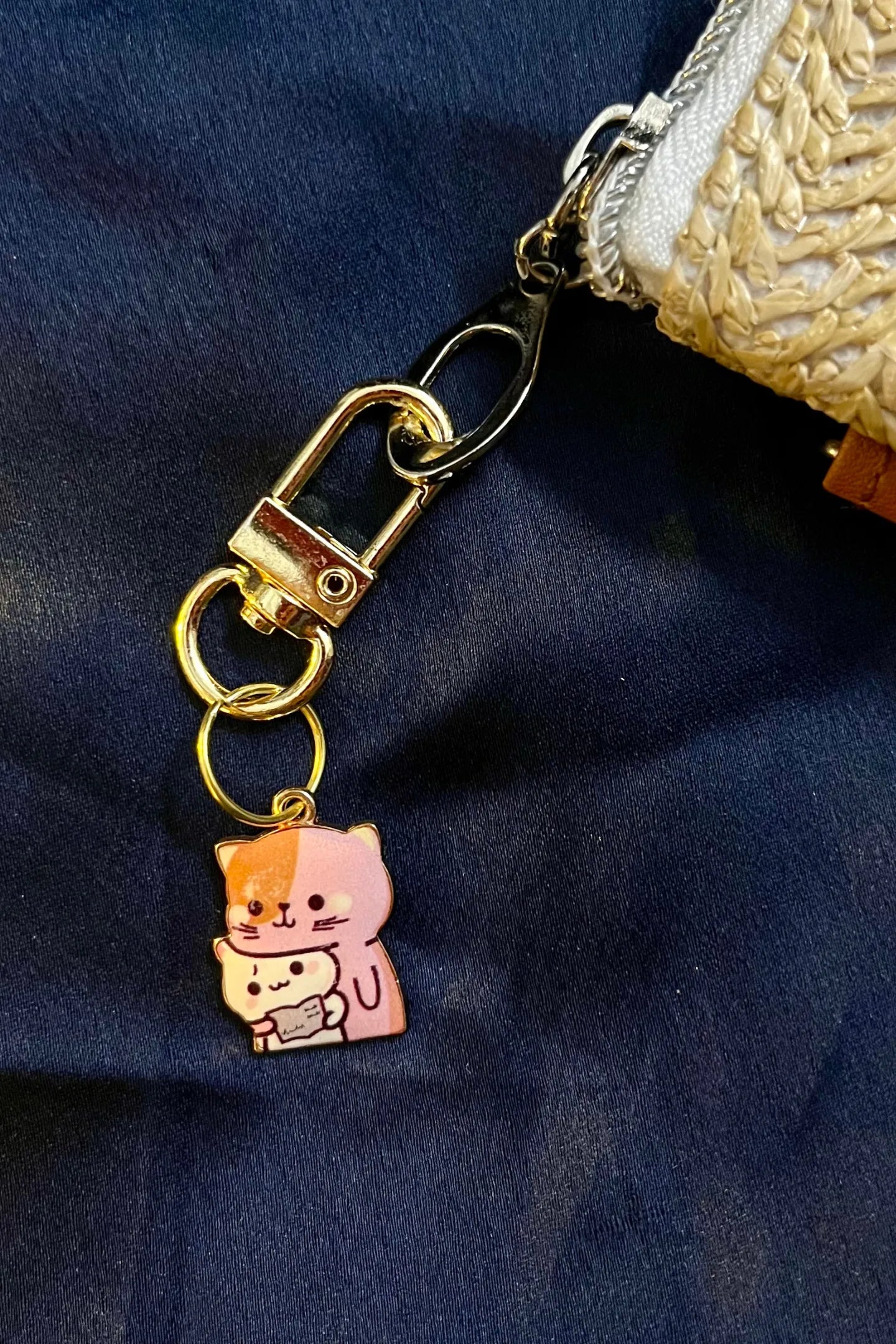 Fifth view of a keychain featuring a design of a mother cat and her kitten.
