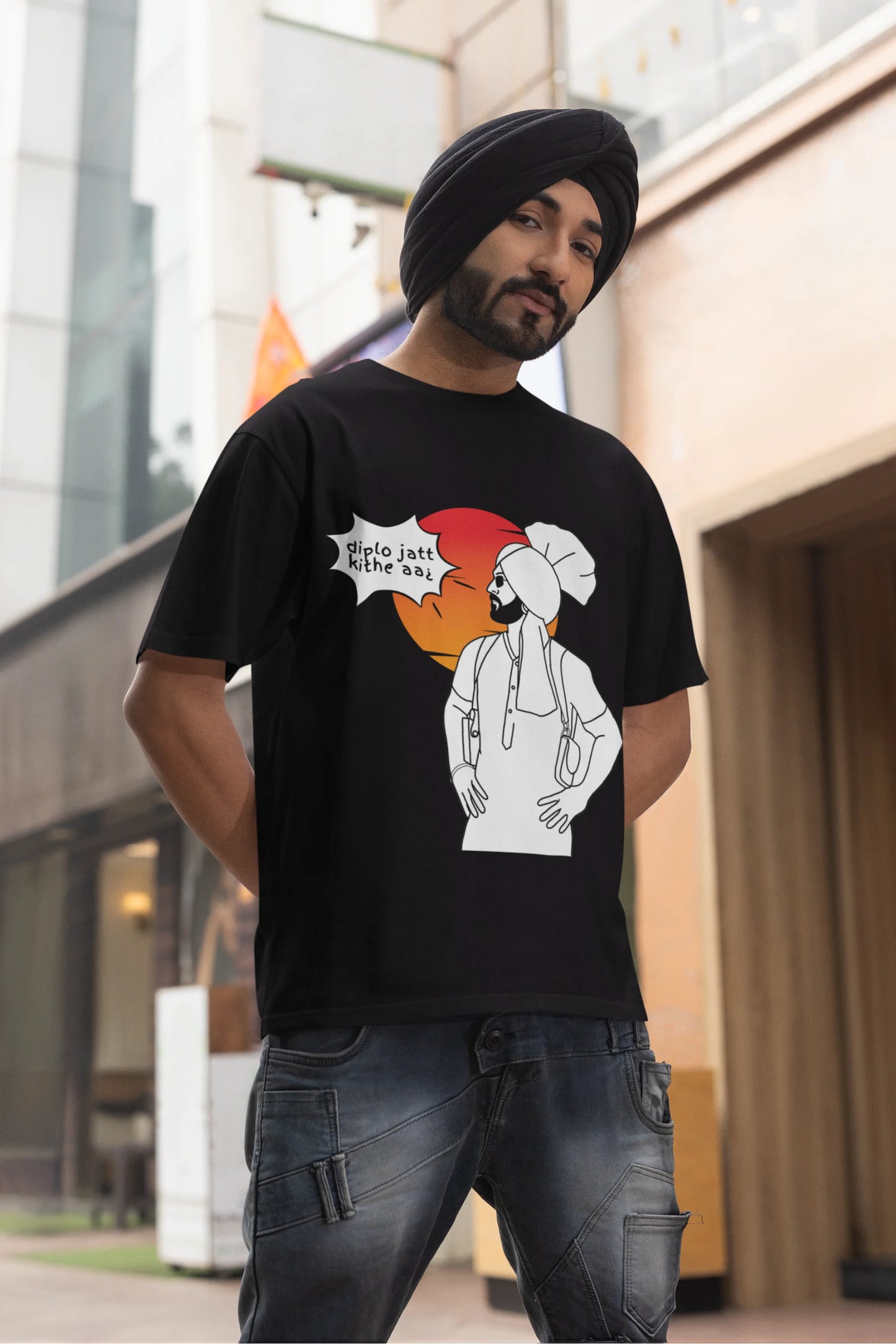 First image of a male model wearing a black oversized tshirt with a A portrait of Diljit Dosanjh wearing a stylish outfit, with the text "Diplo Jatt Kithe Aai" prominently displayed in the background. The design captures the artist's charisma and the energy of the hit song, making it a must-have for fans of Diljit Dosanjh and Diplo alike.