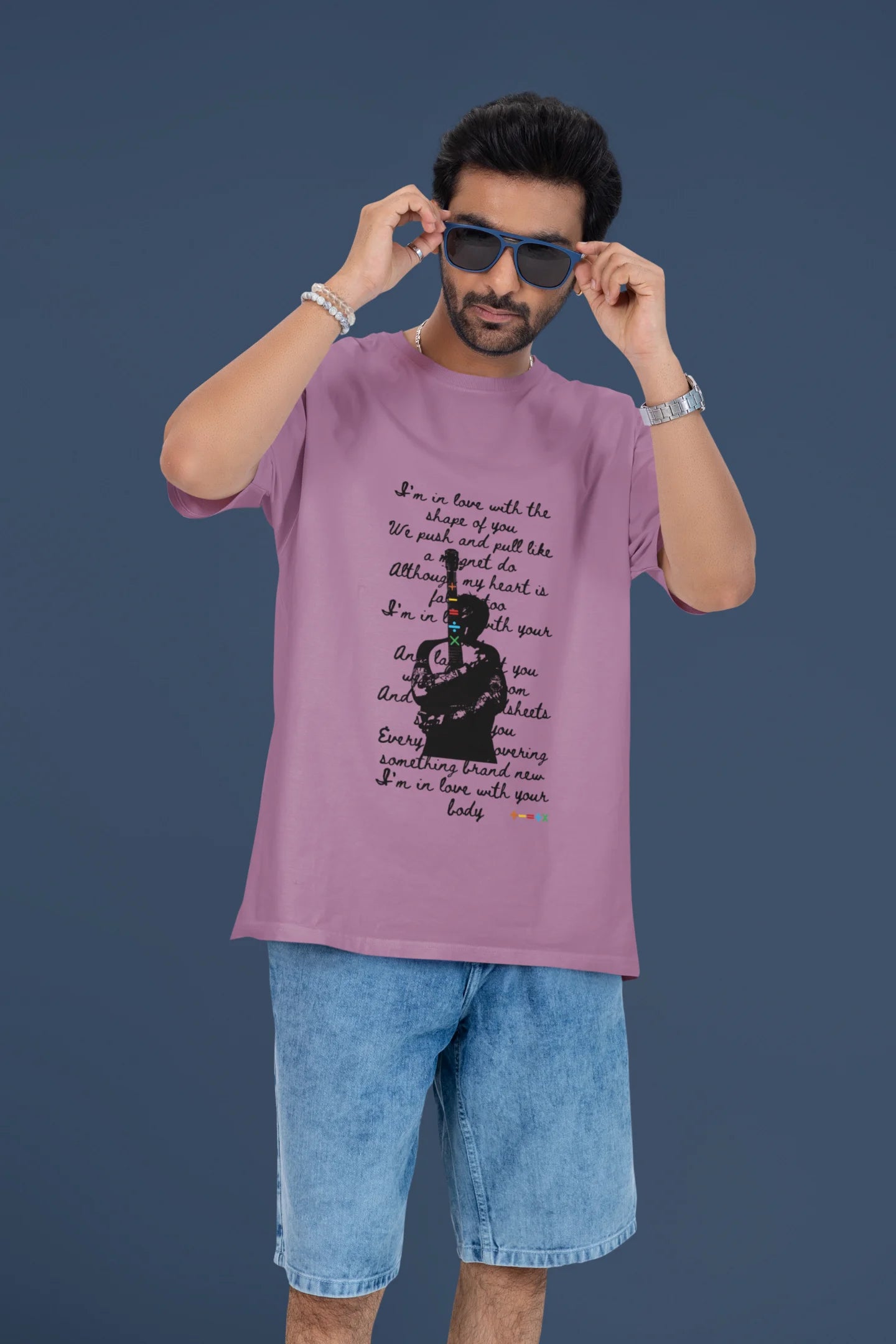 4th front view of a male model wearing a dirty purple oversized t-shirt featuring a design inspired by Ed Sheeran's concerts, related to the song "Shape of You."