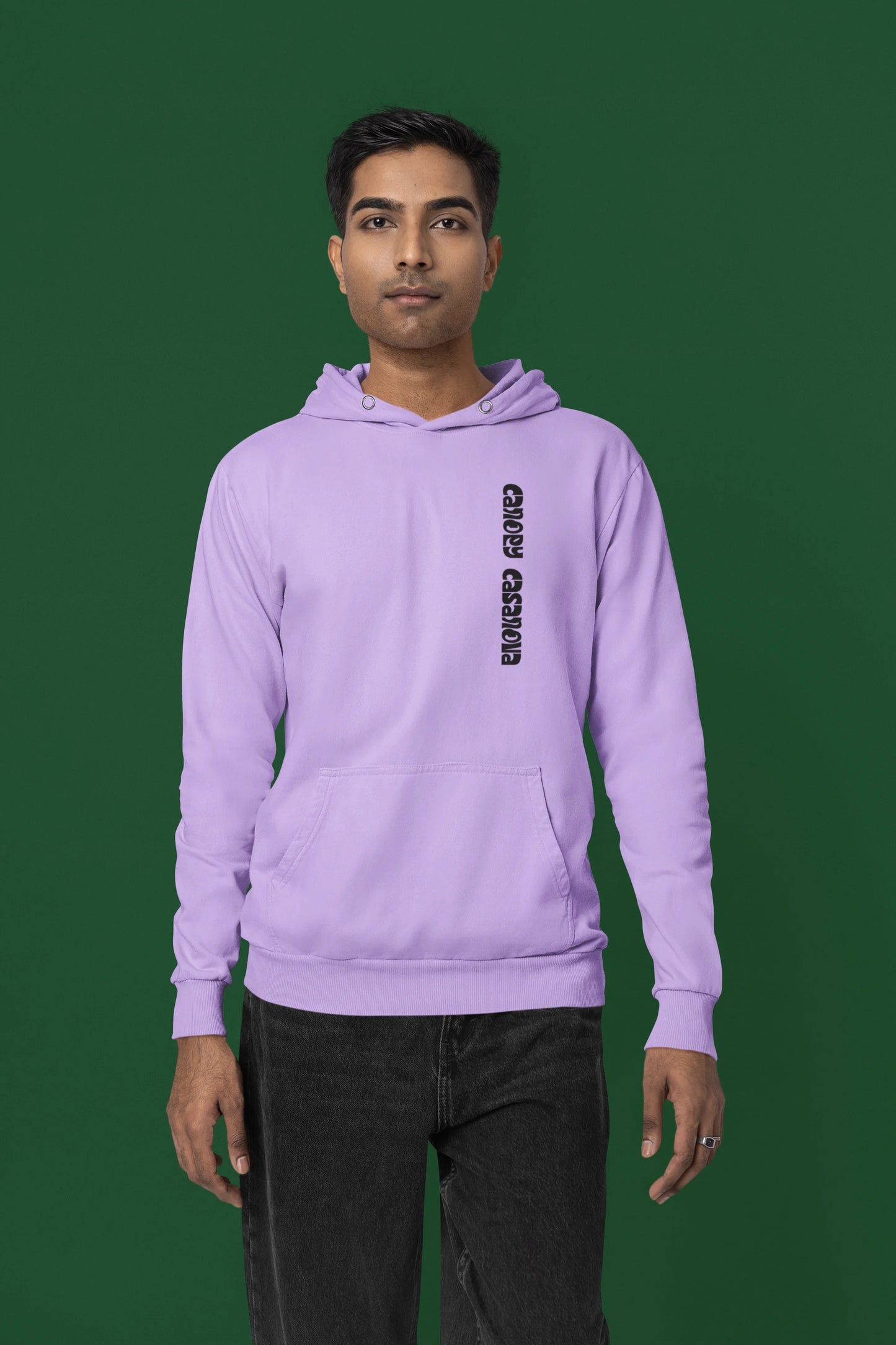 First front view of a male model wearing a lavender hoodie with a toucan perched on a branch in a jungle setting.