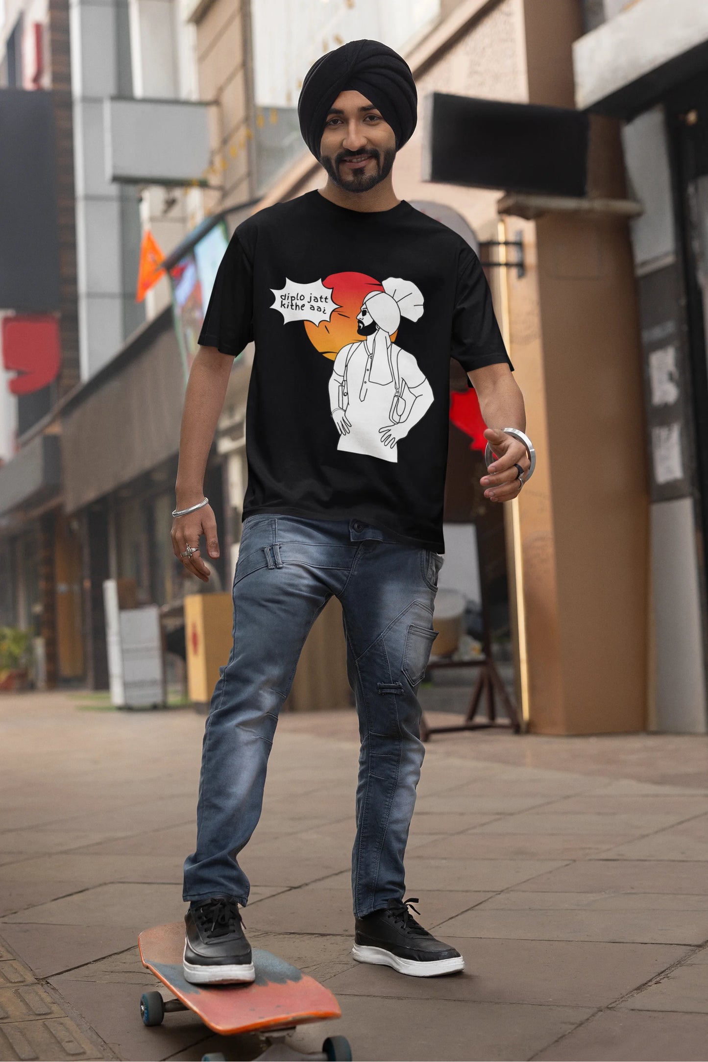 Second image of a male model wearing a black oversized tshirt with a A portrait of Diljit Dosanjh wearing a stylish outfit, with the text "Diplo Jatt Kithe Aai" prominently displayed in the background. The design captures the artist's charisma and the energy of the hit song, making it a must-have for fans of Diljit Dosanjh and Diplo alike.