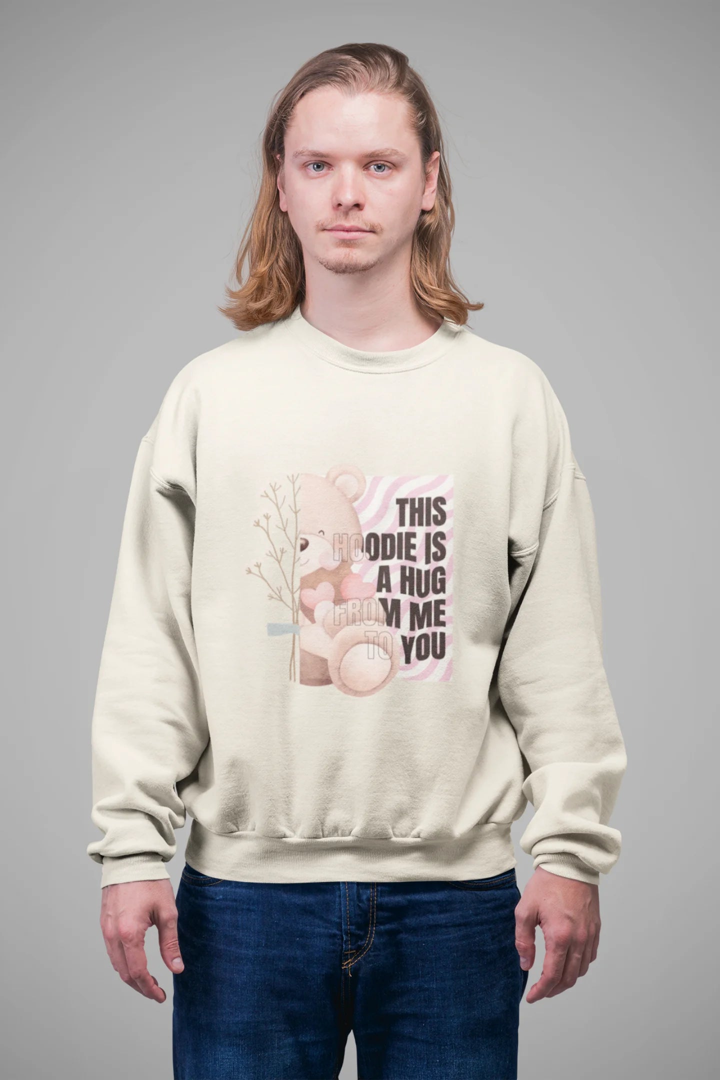 4th front view of a male model wearing a cream sweatshirt with a heartwarming design of a teddy bear offering a hug, offering a comforting and relaxing aesthetic.