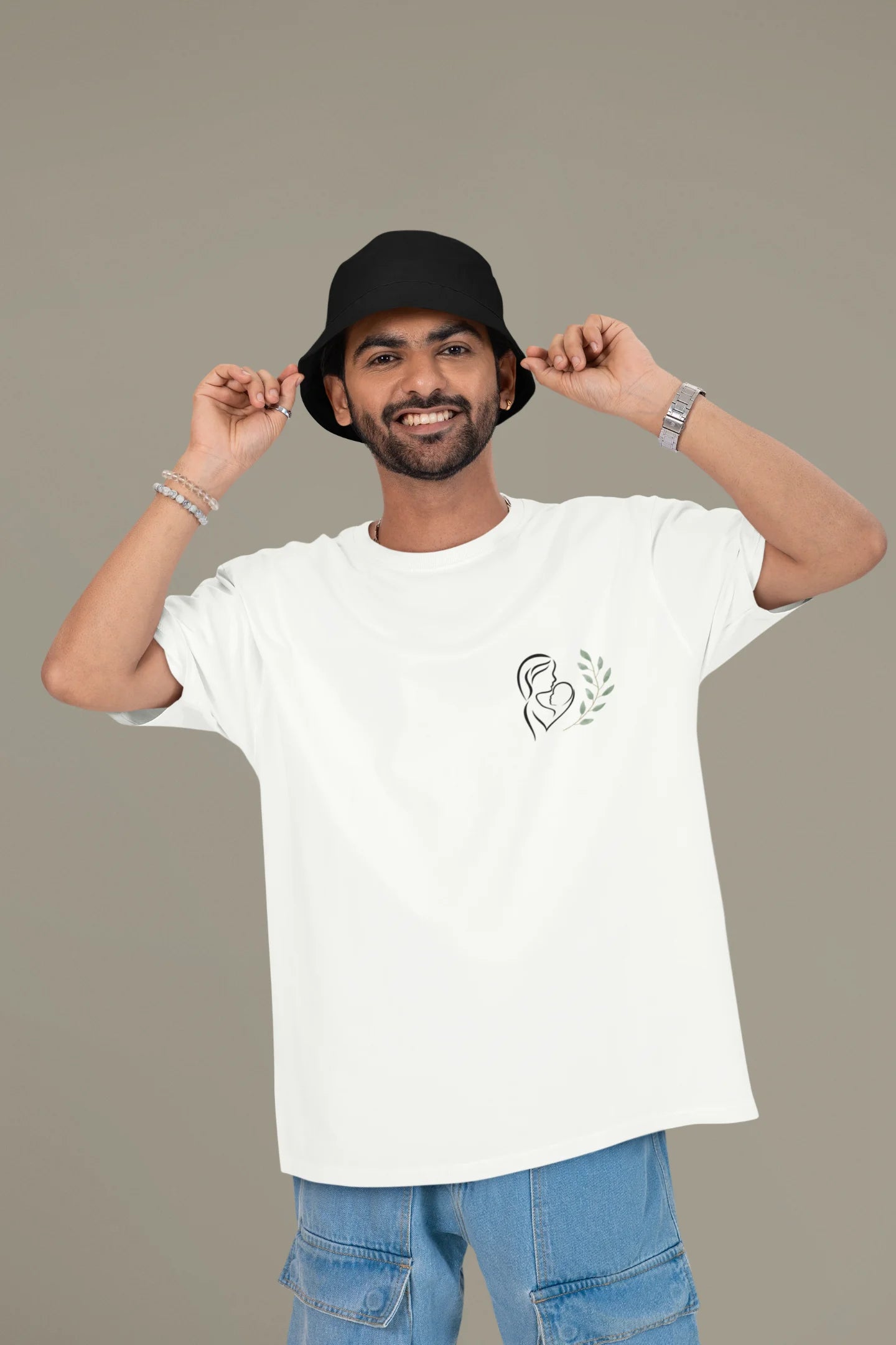 Another front view of a male model wearing an off-white oversized t-shirt featuring a design depicting a mother tenderly holding a baby